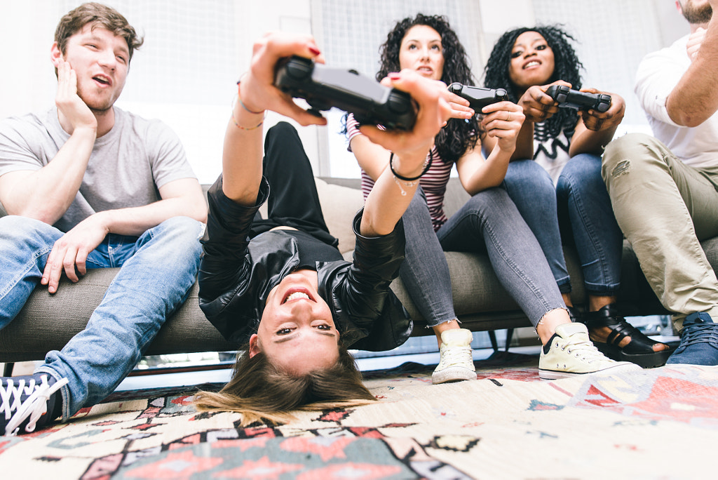 Group of friends playing hard with video games. by Cristian Negroni on 500px.com