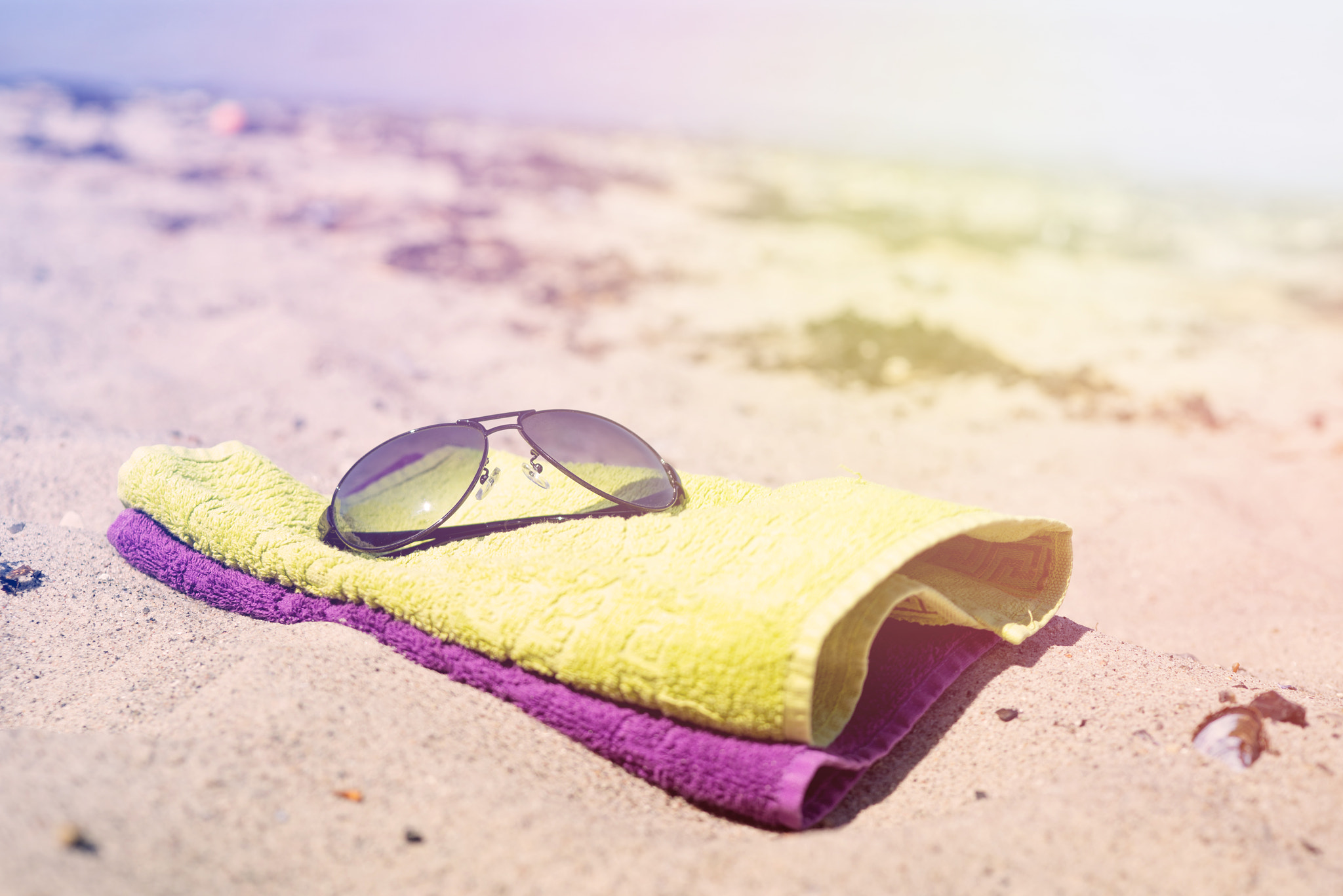 Sony a7R + Sony 50mm F1.4 sample photo. Beach towels with sunglasses photography