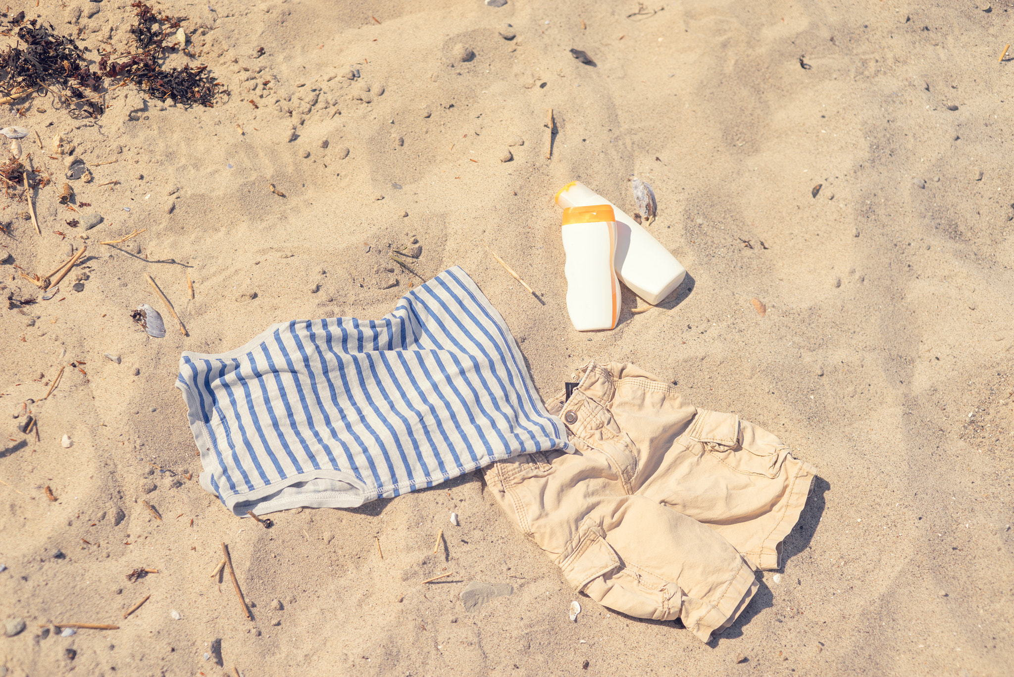 Sony a7R + Sony 50mm F1.4 sample photo. Kids clothes on a sandy beach photography