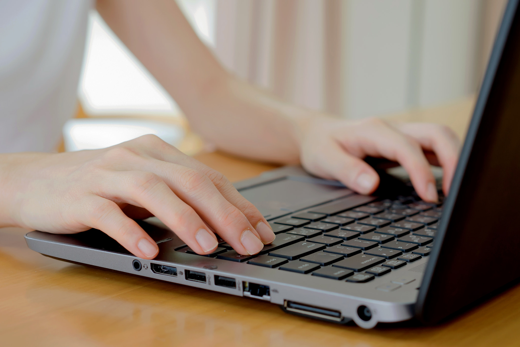 Sony a7 + E 50mm F1.8 OSS sample photo. Programmer's hand typing with laptop. focus on his finger photography