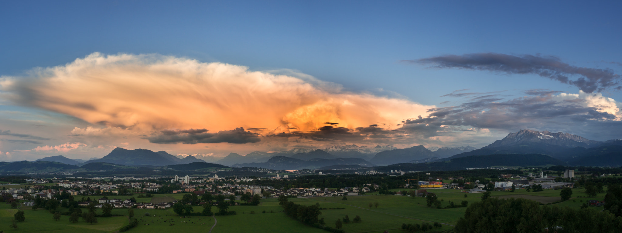 Sony Alpha NEX-5T + Sony E 16mm F2.8 sample photo. Thunderstorm above swiss alps in the evening sun photography