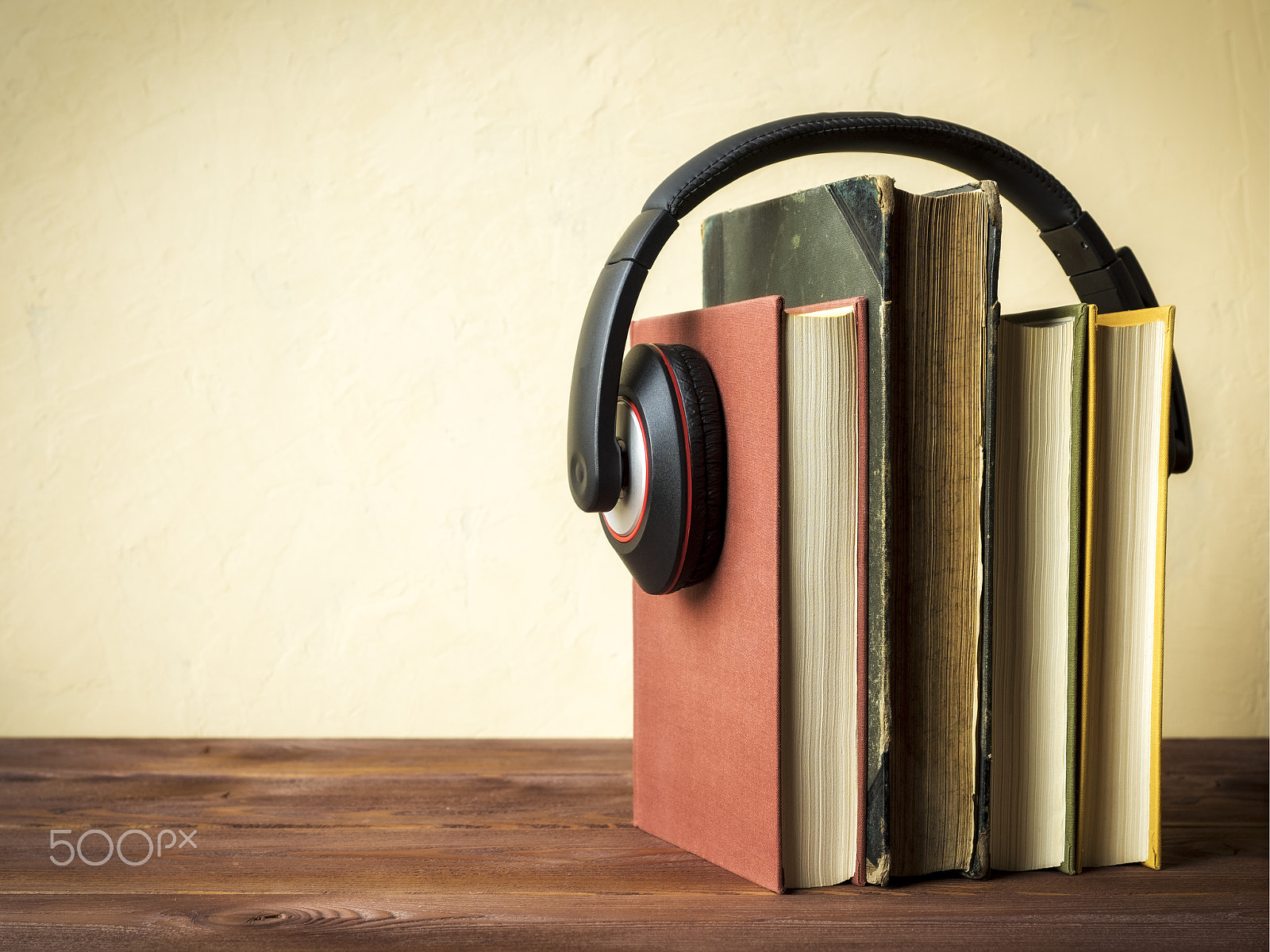 Olympus OM-D E-M1 + OLYMPUS 14-54mm Lens sample photo. Pile of books with headphones photography