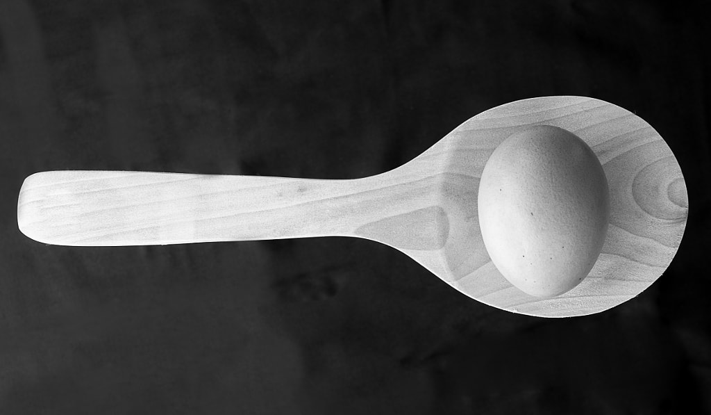 egg with the shell on top of a wooden spoon, for a still life in black and white by Giampiero Acri on 500px.com