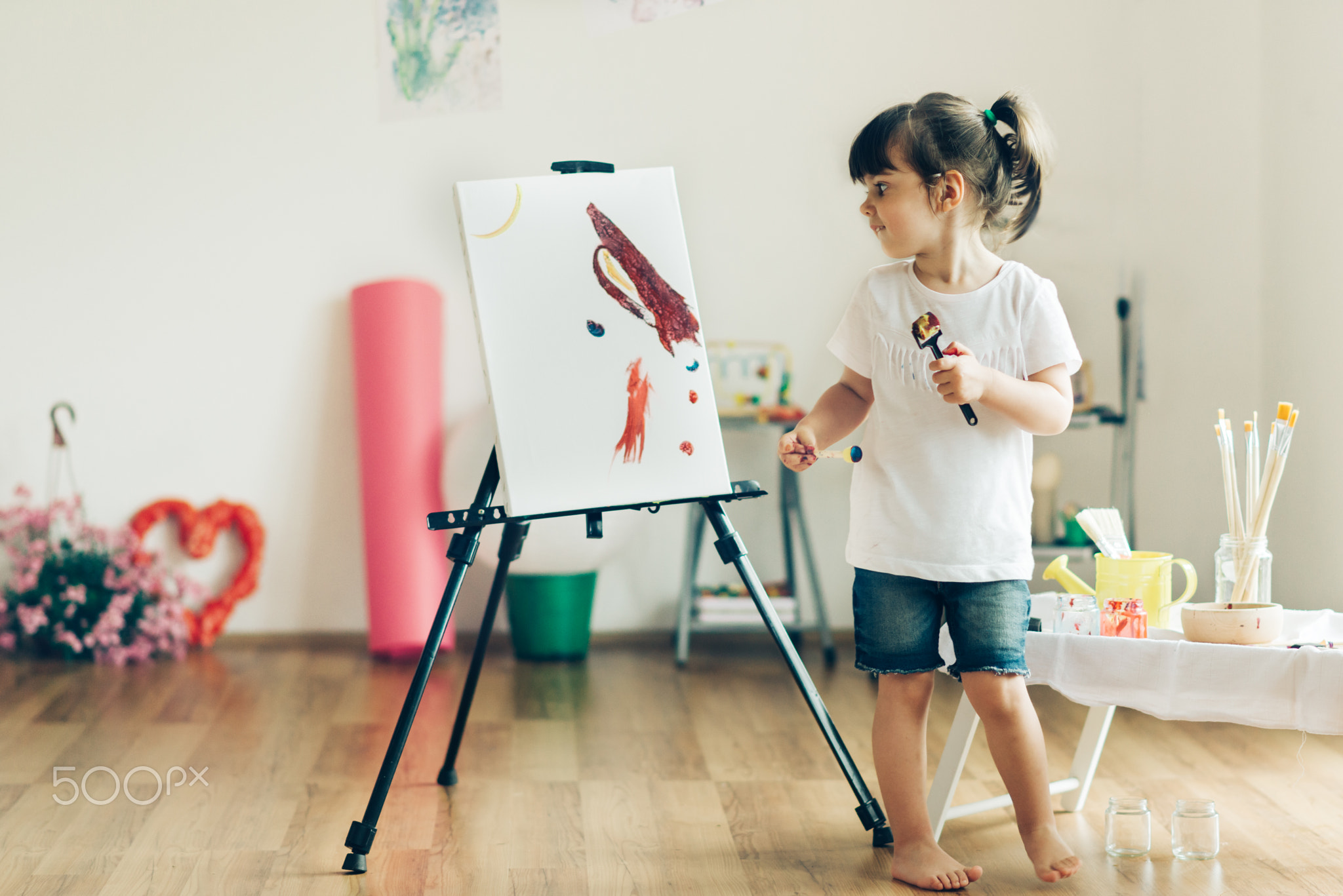 Cut girl painting in at her  home