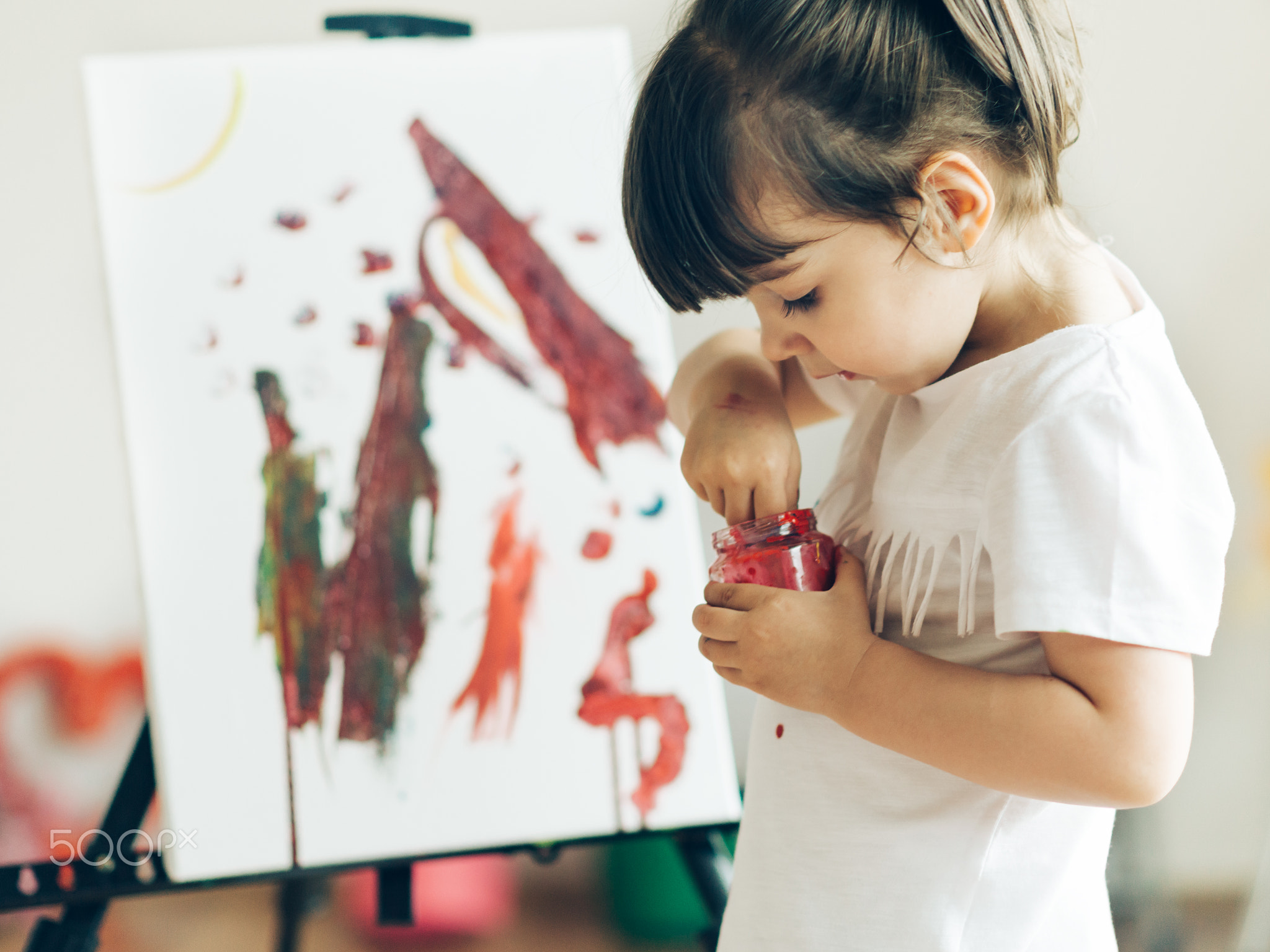 Cut girl painting in at her  home