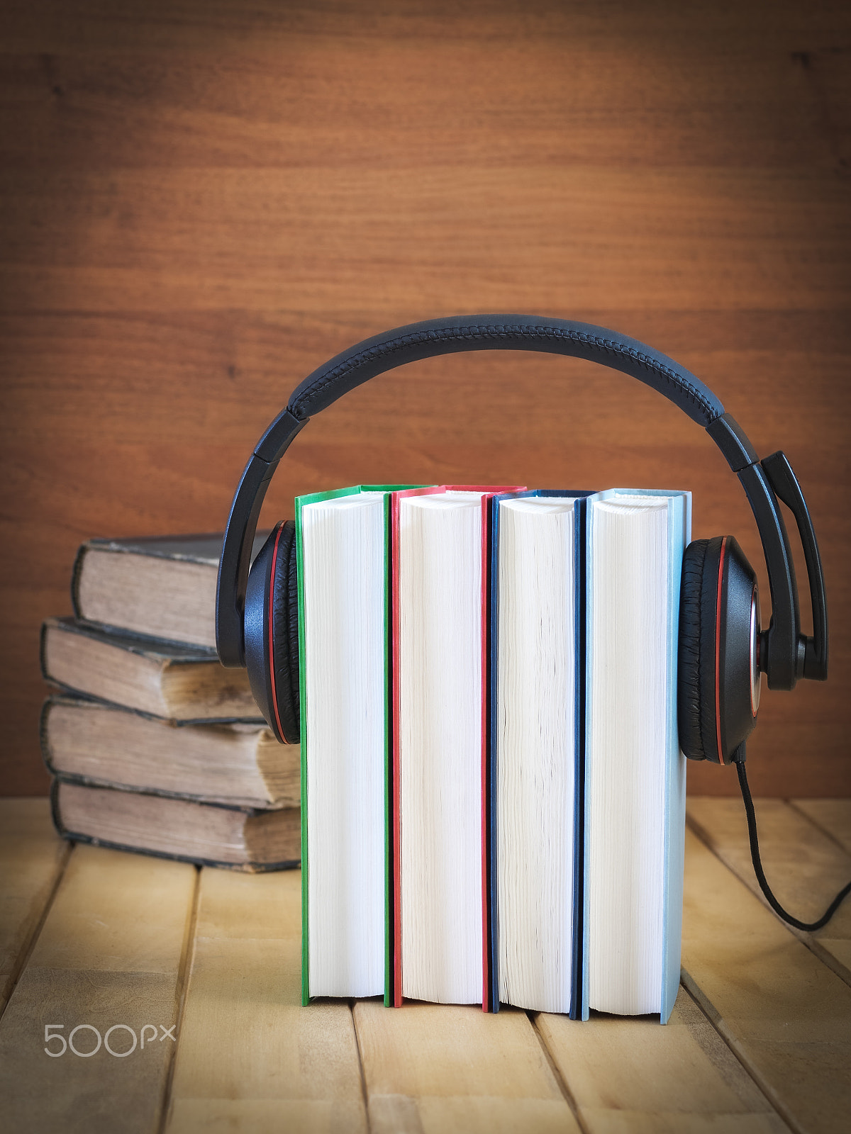 Olympus OM-D E-M1 + OLYMPUS 50mm Lens sample photo. Pile of books with headphones photography