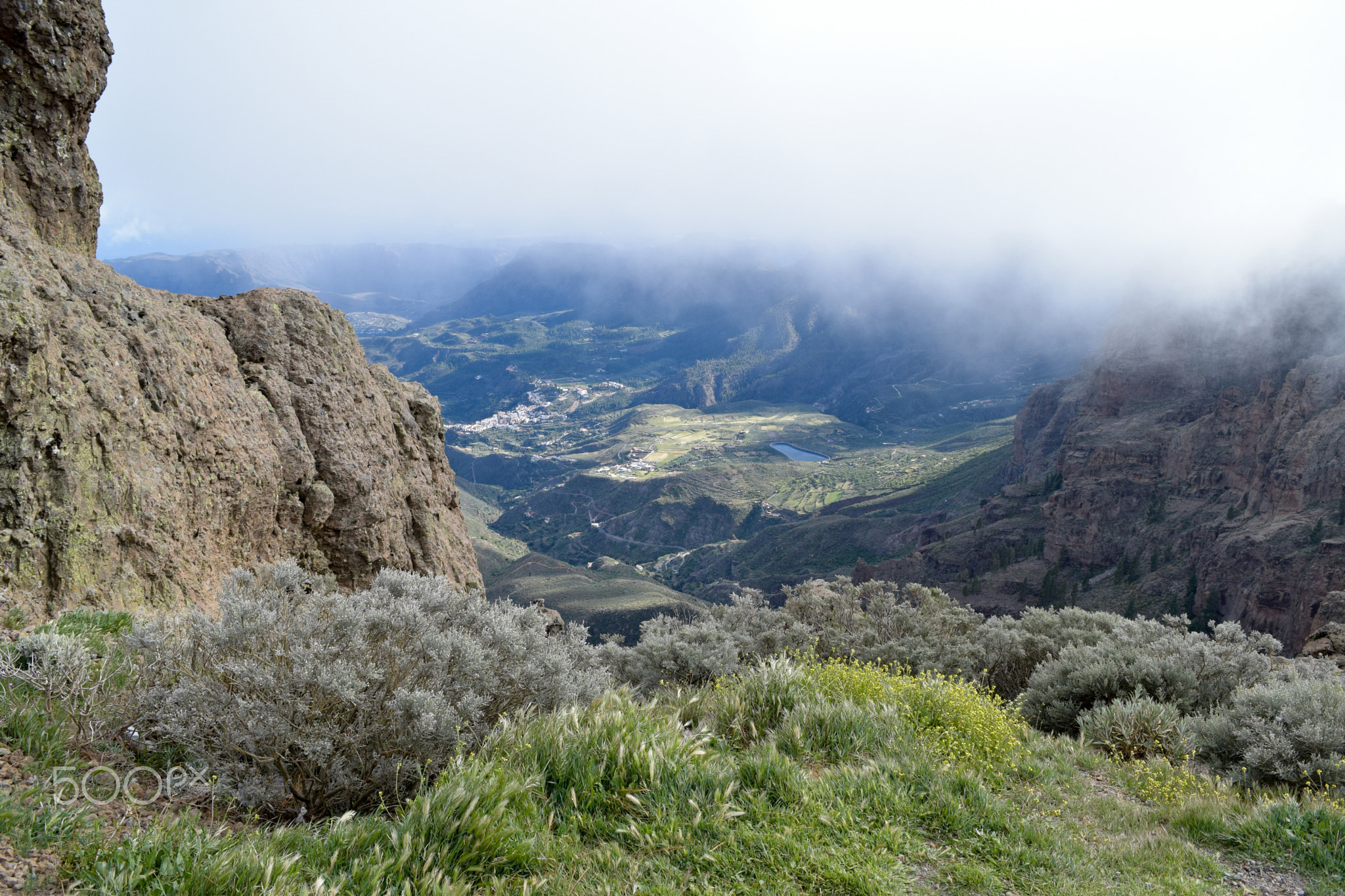 In the clouds looking down from heaven