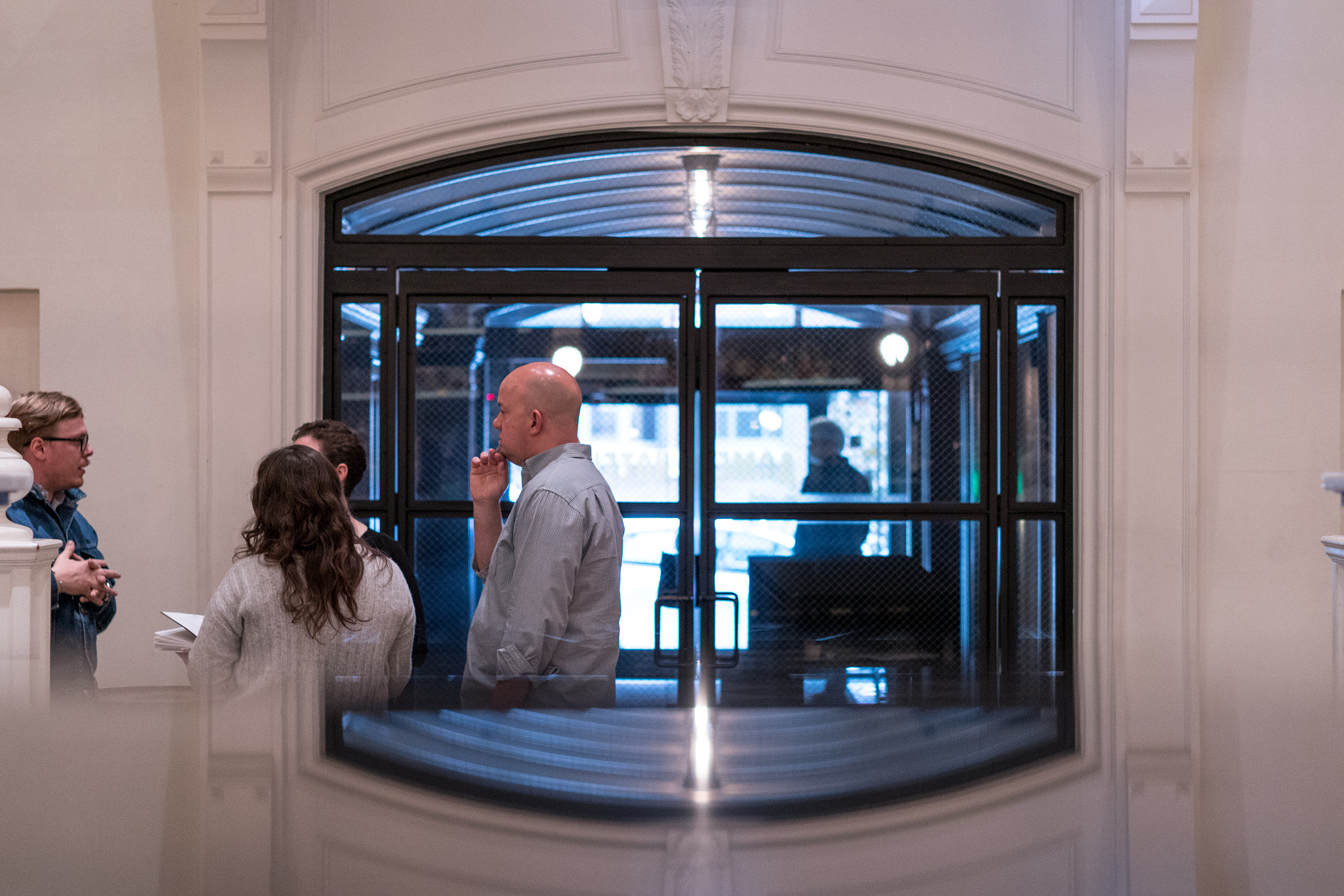 E 50mm F2 sample photo. A reflective conversation photography