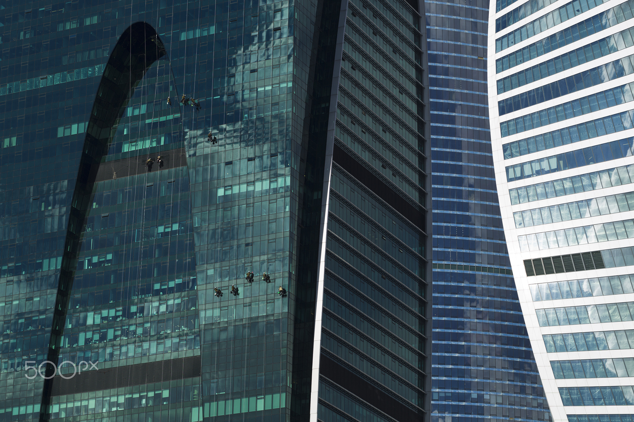Industrial climbers cleaned glass wall of a skyscraper