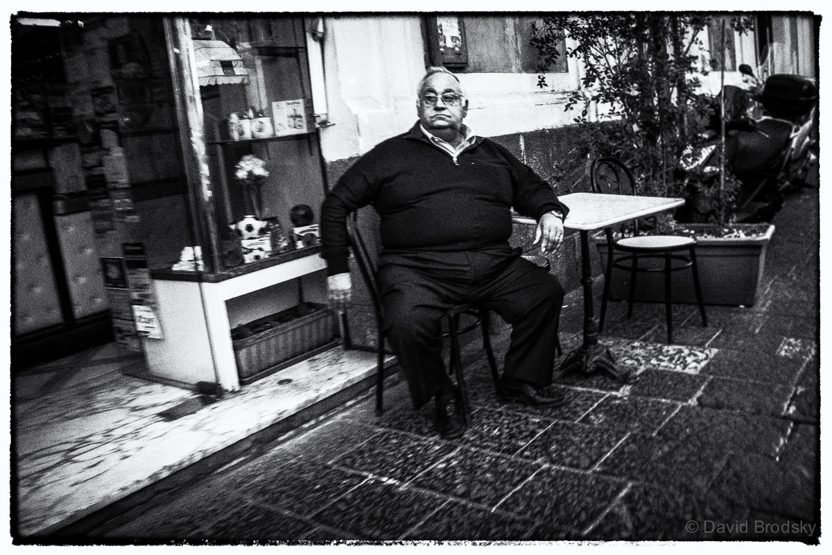 Sony E 18-200mm F3.5-6.3 OSS LE sample photo. Sitting man photography