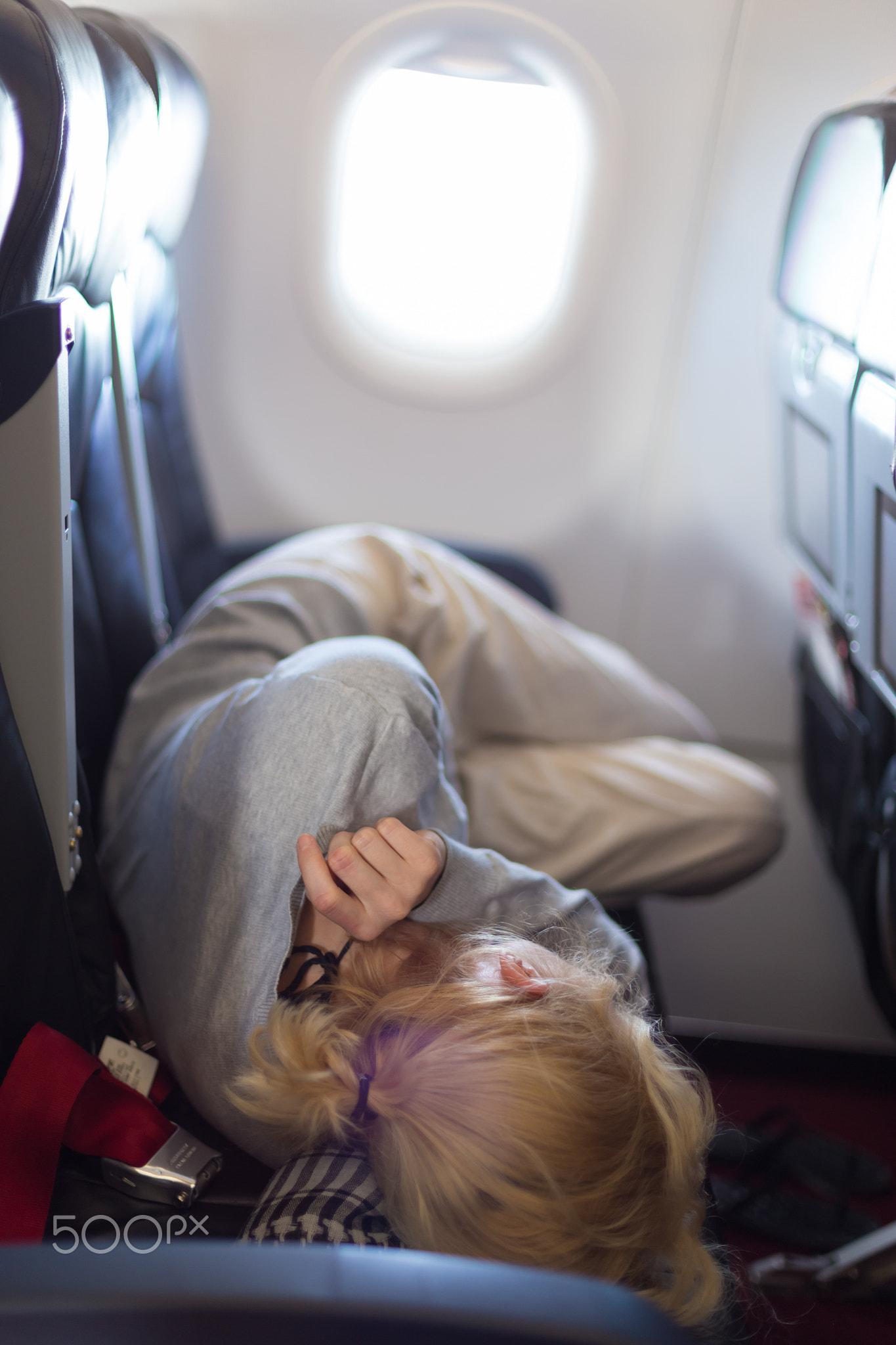 Young woman sleeping on airplane