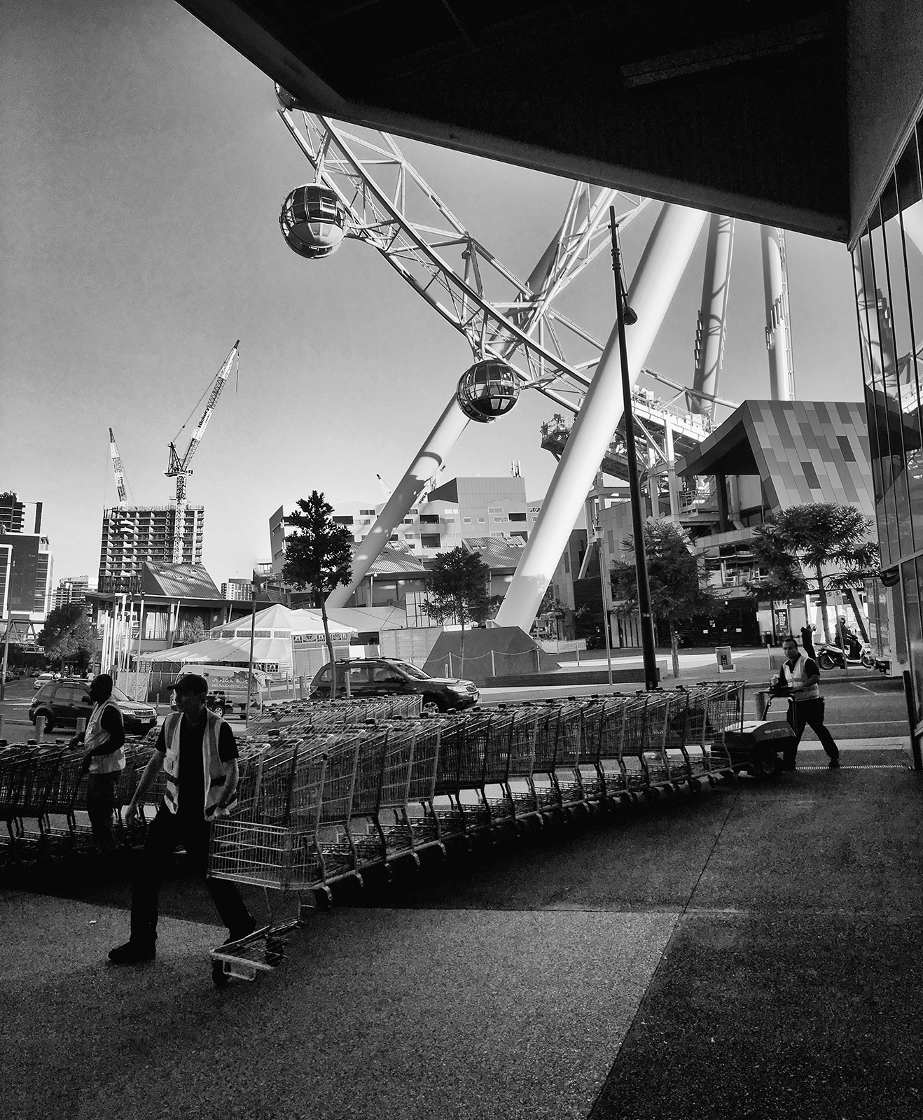 Apple iPhone8,1 sample photo. Man with trolleys photography