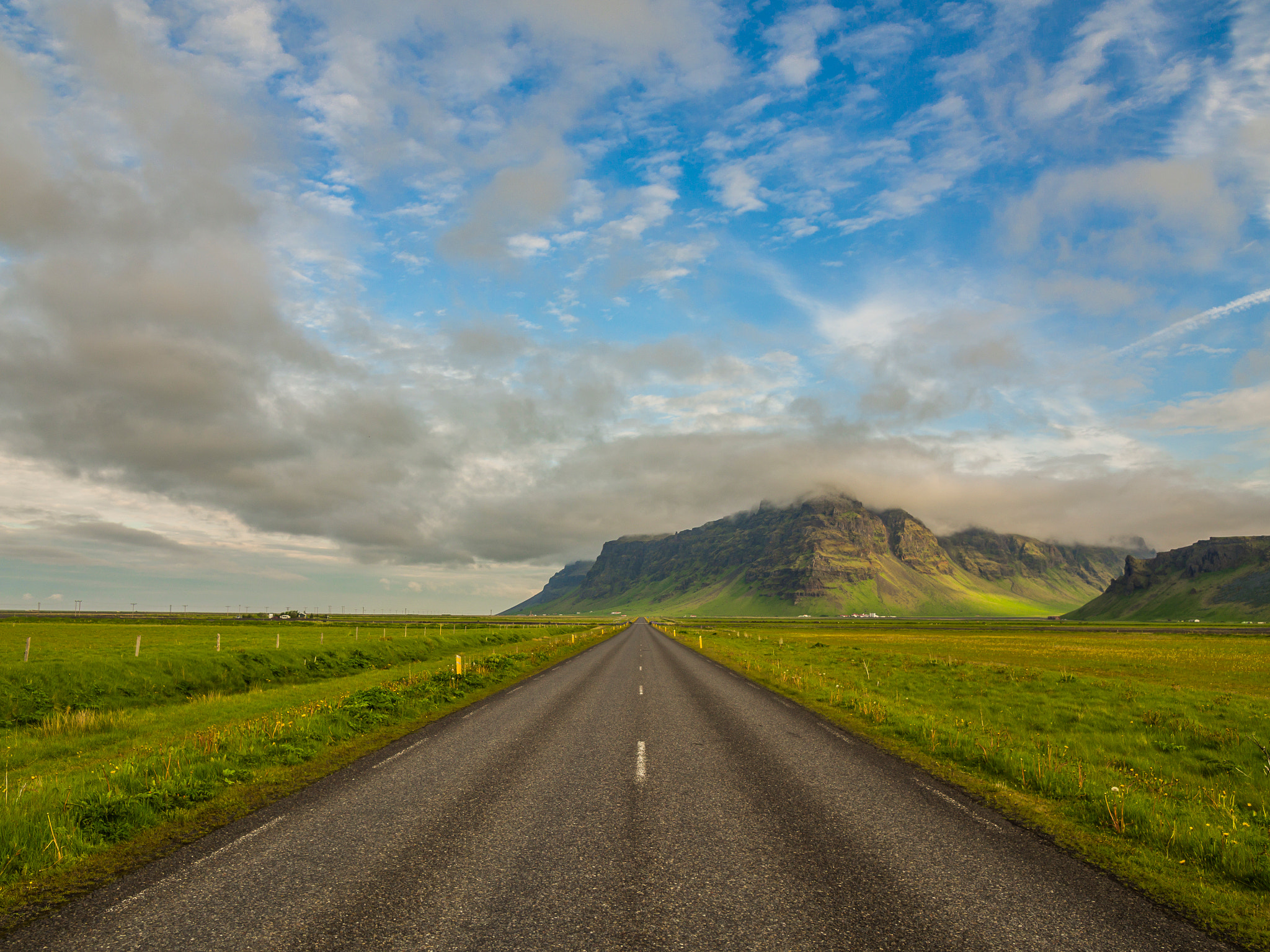 Olympus OM-D E-M5 + Olympus M.Zuiko Digital ED 7-14mm F2.8 PRO sample photo. A road leading away into the mountains in iceland. photography