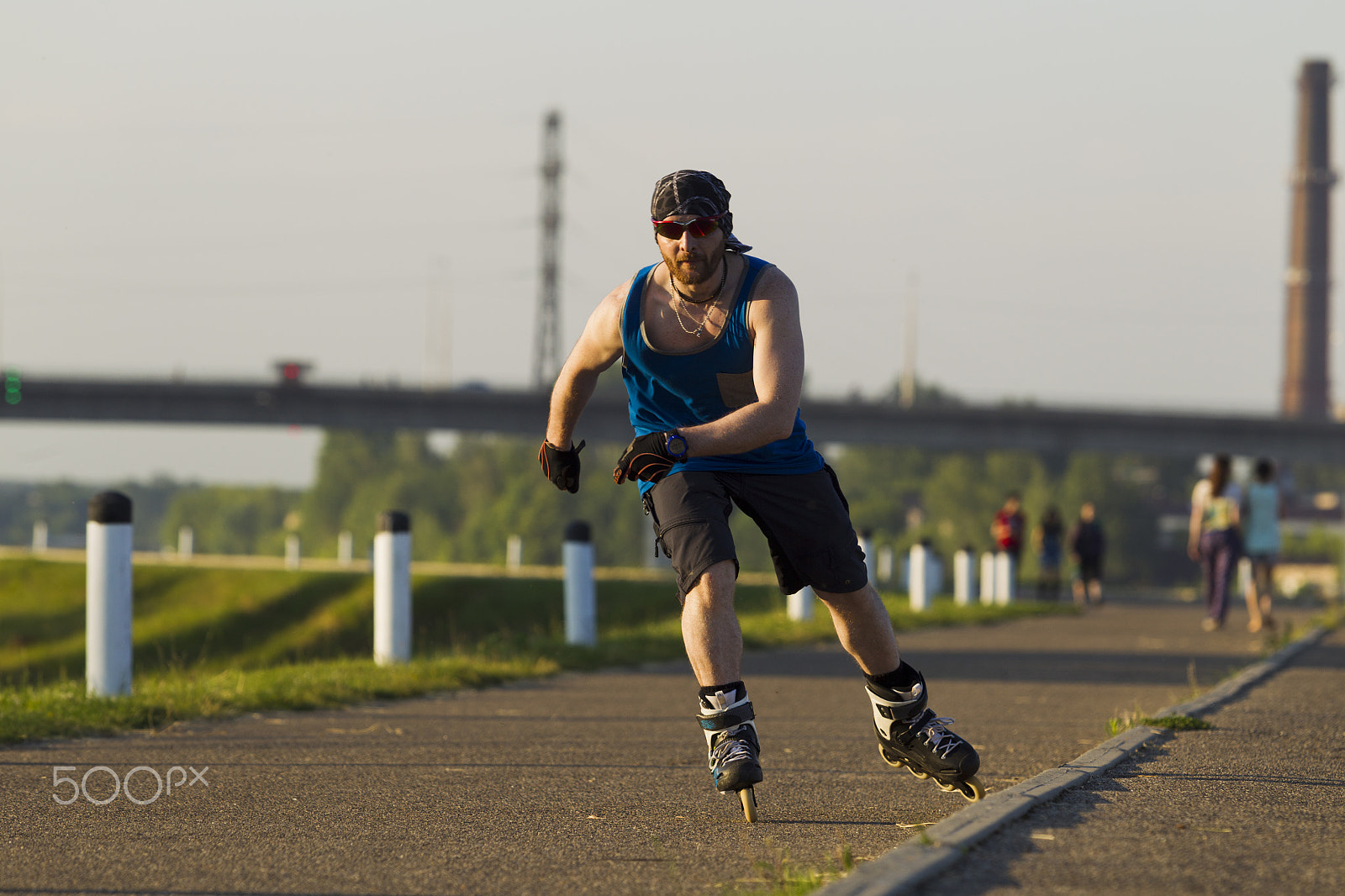 Canon EOS-1D Mark IV sample photo. A man riding on roller skates in the city photography
