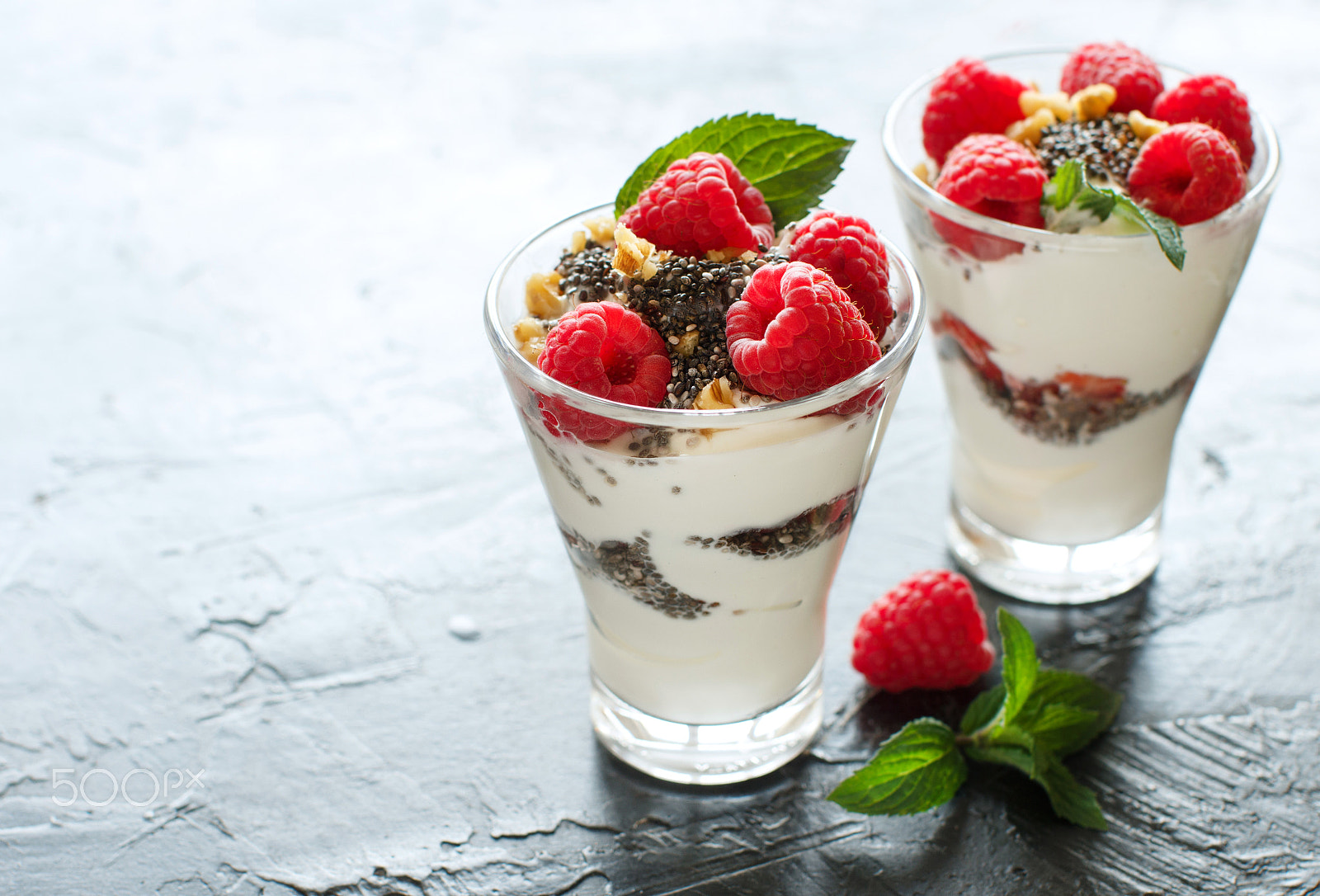 Canon EOS 650D (EOS Rebel T4i / EOS Kiss X6i) + Canon EF 50mm F1.2L USM sample photo. Yogurt with chia seeds, walnuts and raspberries photography