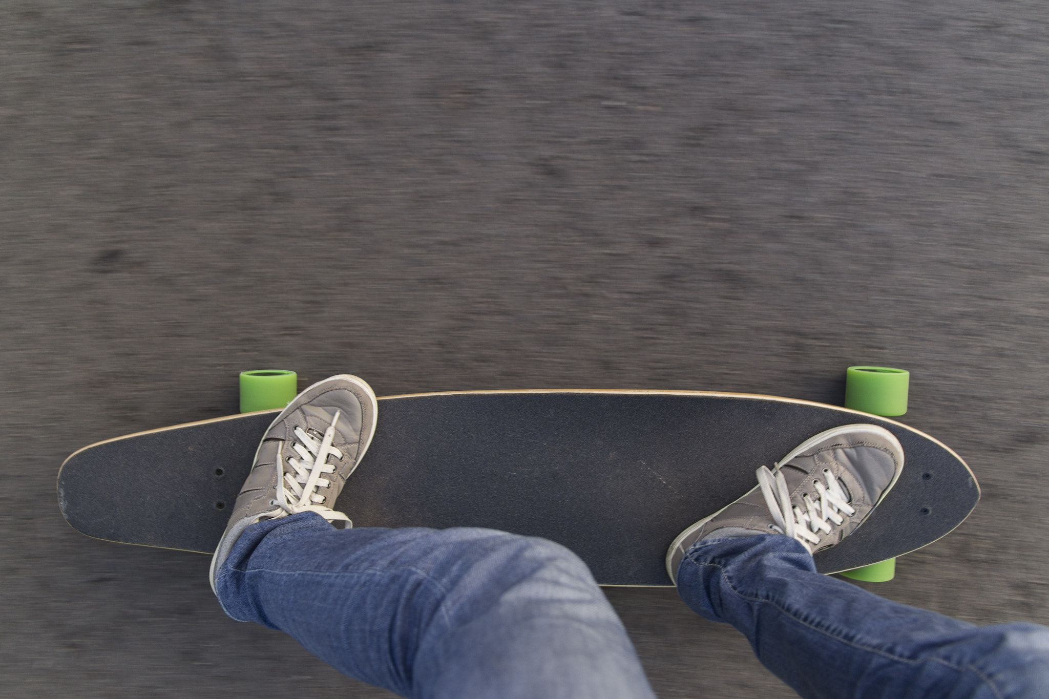 Sigma 17-70mm F2.8-4 DC Macro OS HSM sample photo. Fast longboard riding, top view with negative spaceс. photography