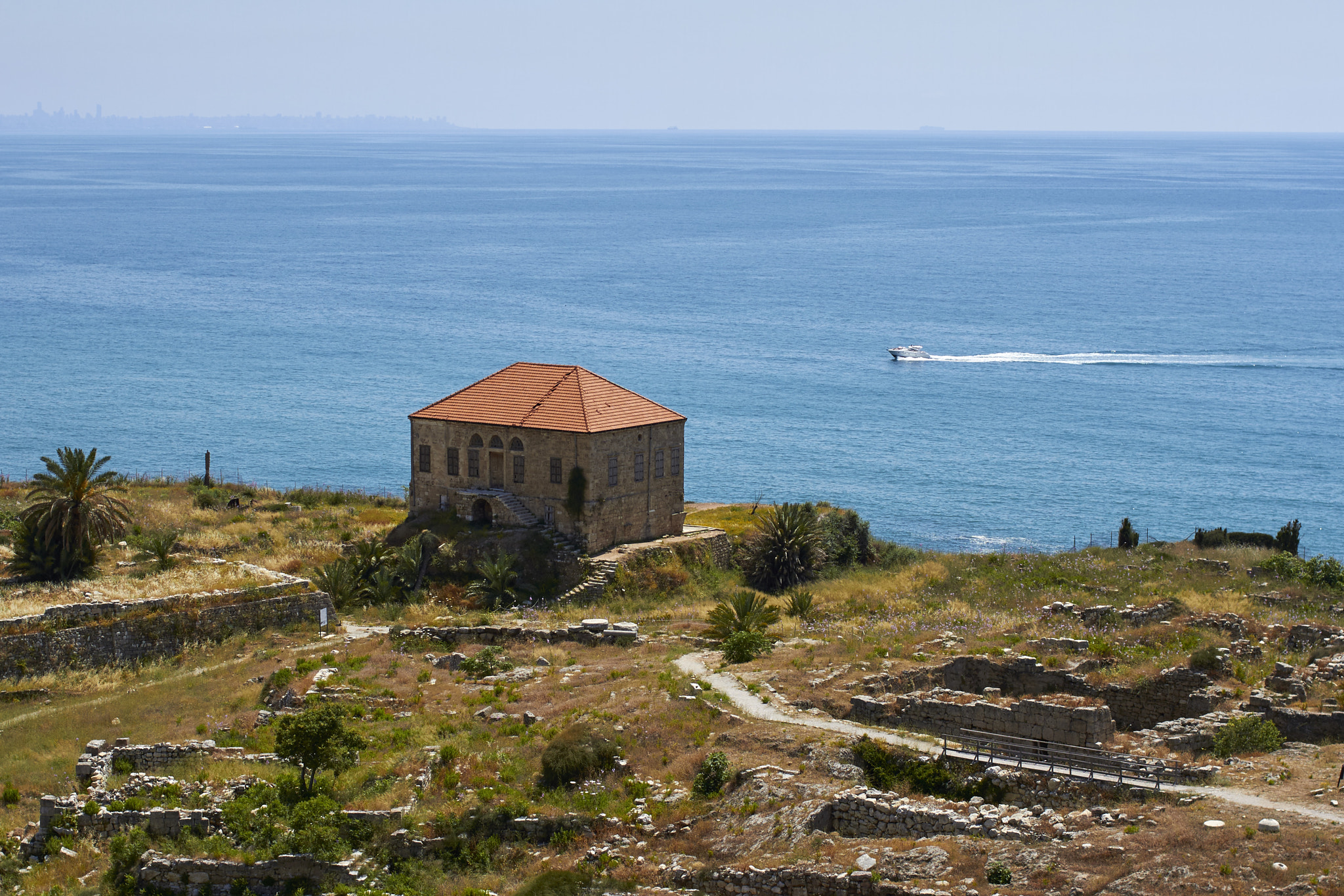 Canon EOS 7D + Canon EF 35mm F2 sample photo. Seaside house surrounded millennial ruins photography