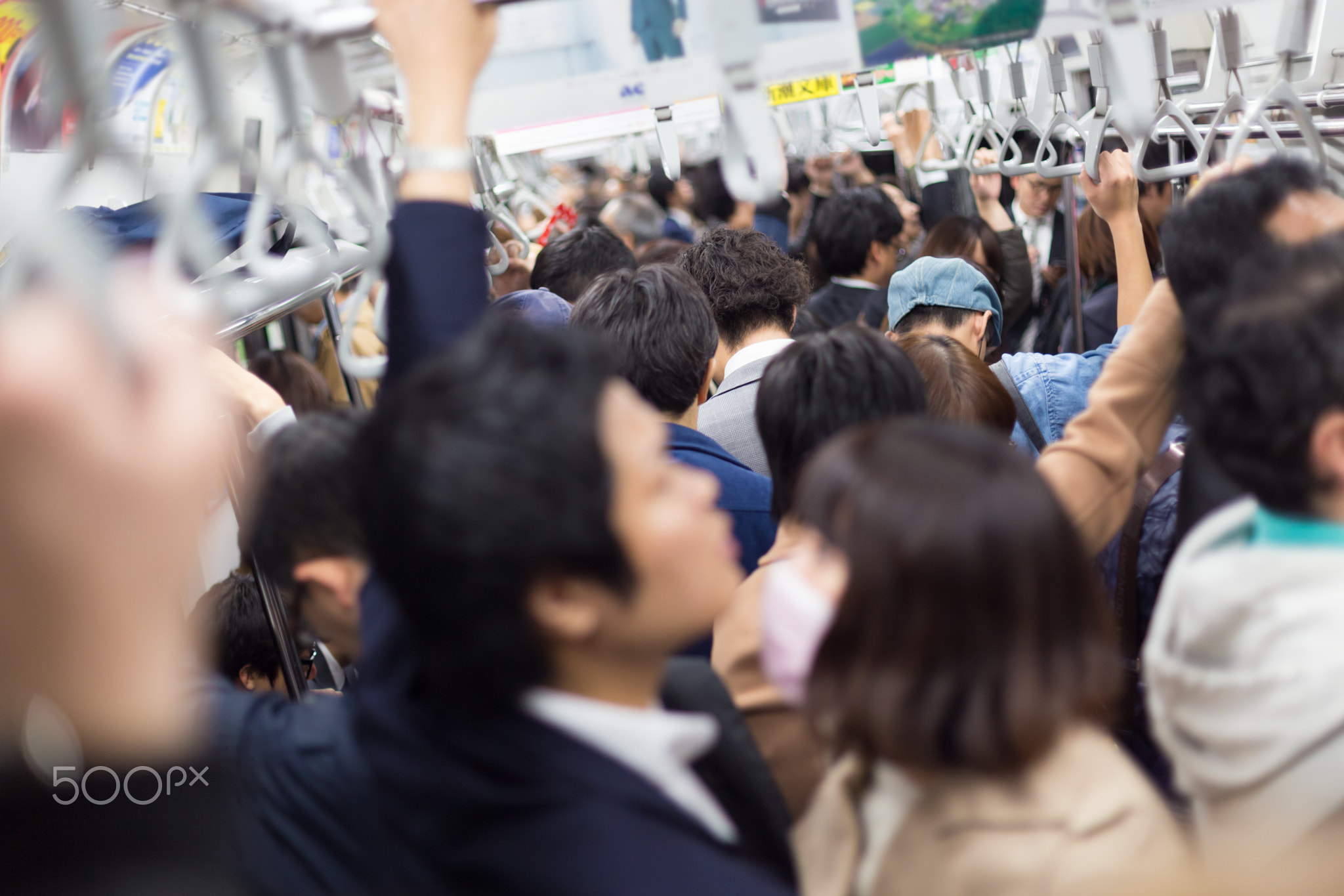 Passengers traveling by Tokyo metro.