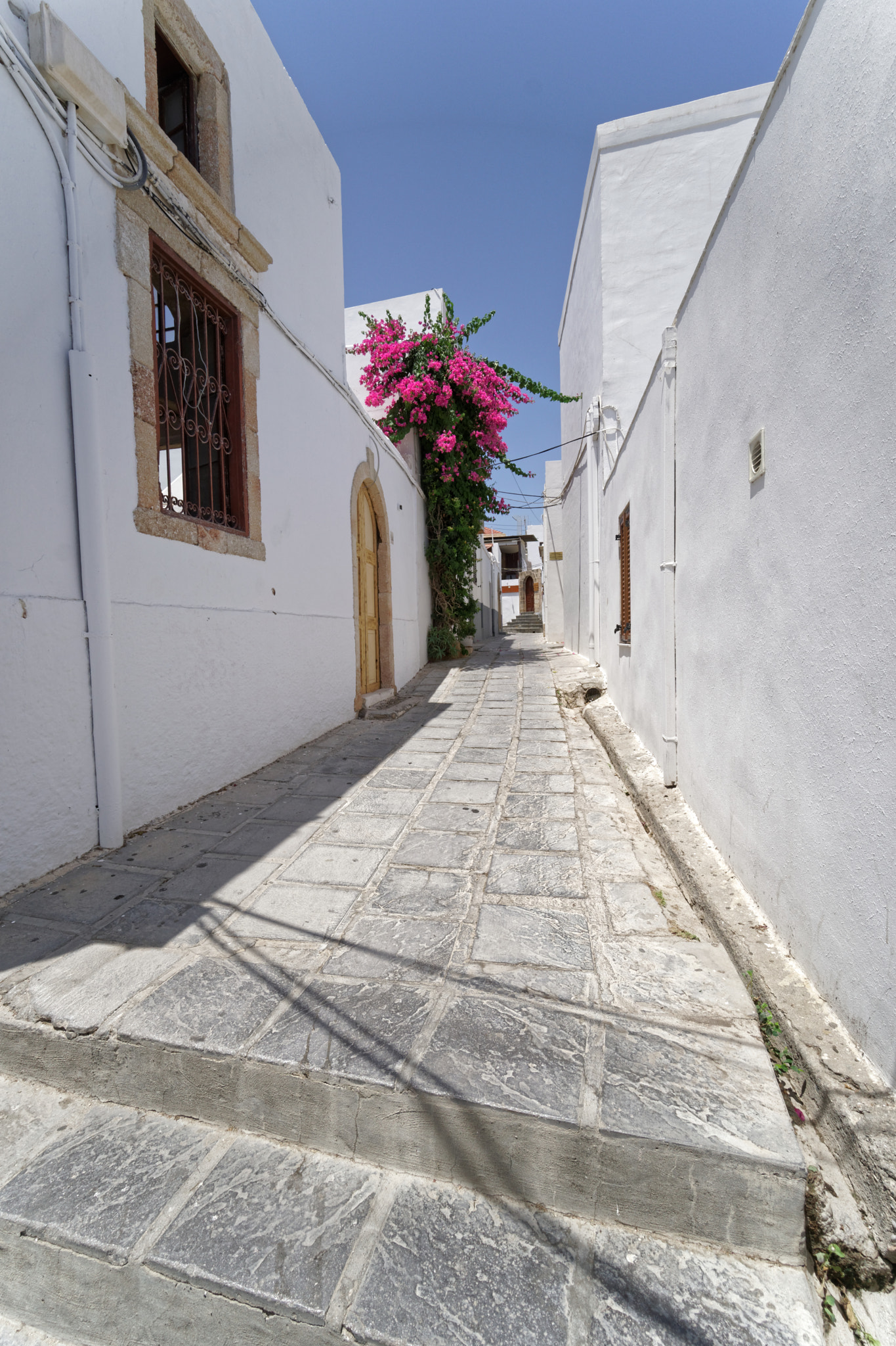 Sony a6300 + Sony E 10-18mm F4 OSS sample photo. Lindos street white & pink photography