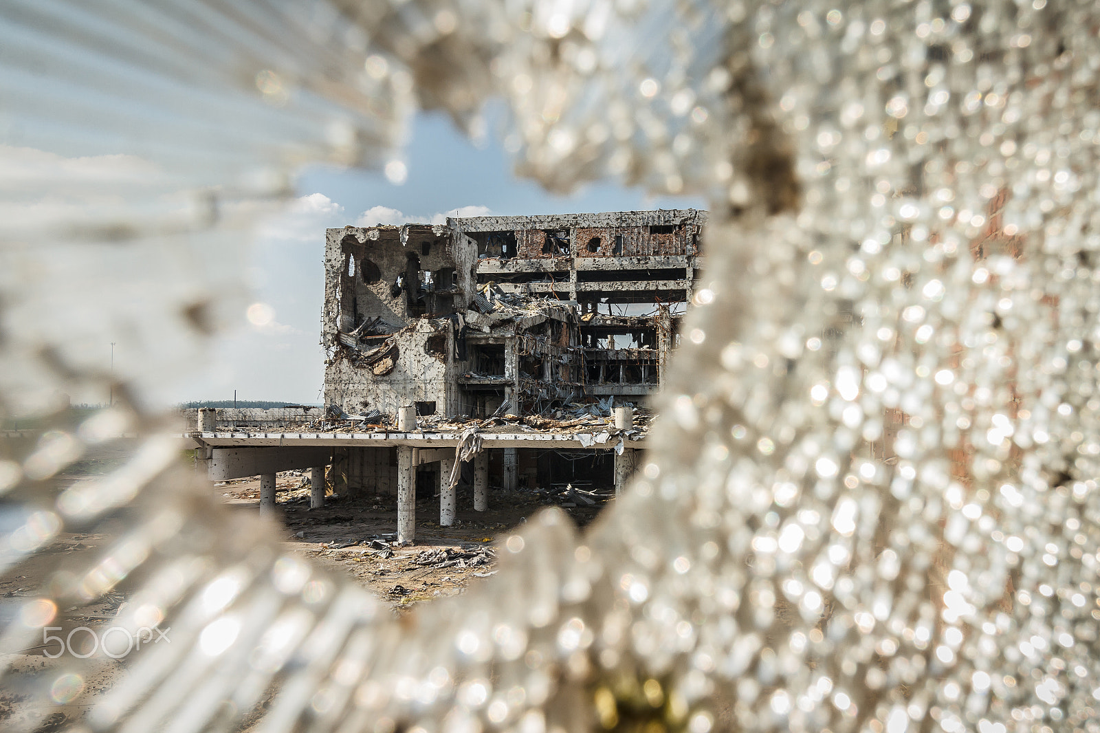 Canon EF-S 10-18mm F4.5–5.6 IS STM sample photo. Wide angle view of airport ruins through glass photography