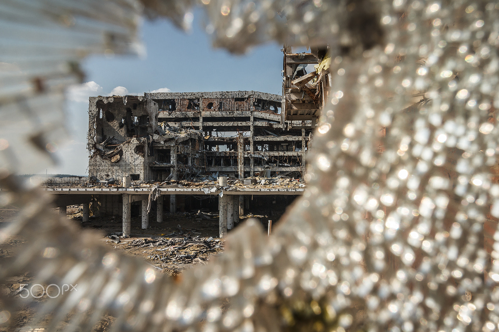 Canon EF-S 10-18mm F4.5–5.6 IS STM sample photo. Wide angle view of airport ruins through glass photography