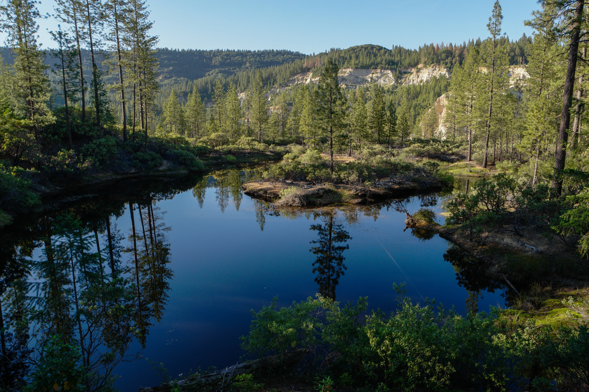 Samsung NX1 + Samsung NX 16-50mm F3.5-5.6 Power Zoom ED OIS sample photo. Devastation and beauty reflected in a mountain pon ... photography