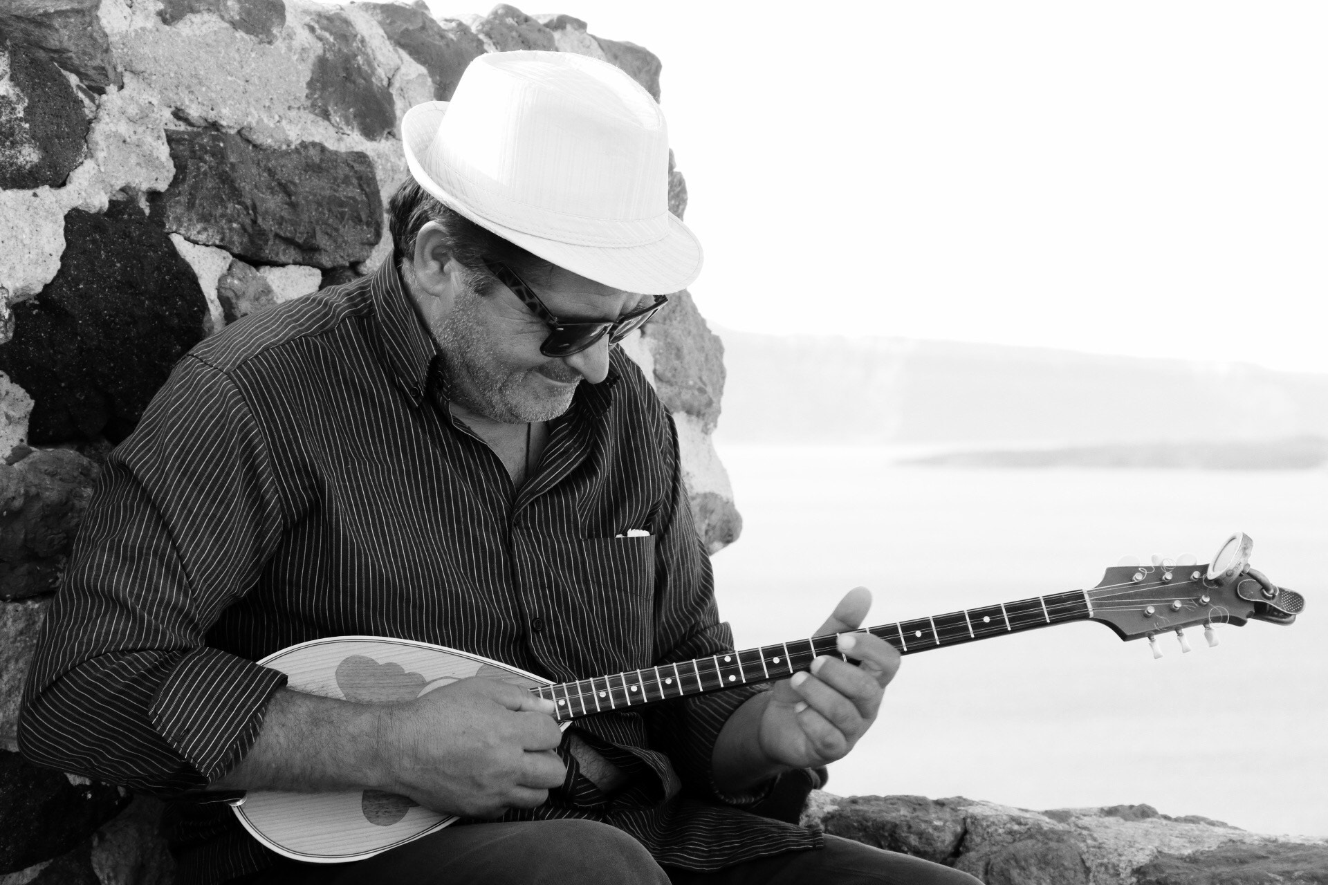 Canon EF-S 18-135mm F3.5-5.6 IS sample photo. An old street musician practicing in the quiet of  ... photography