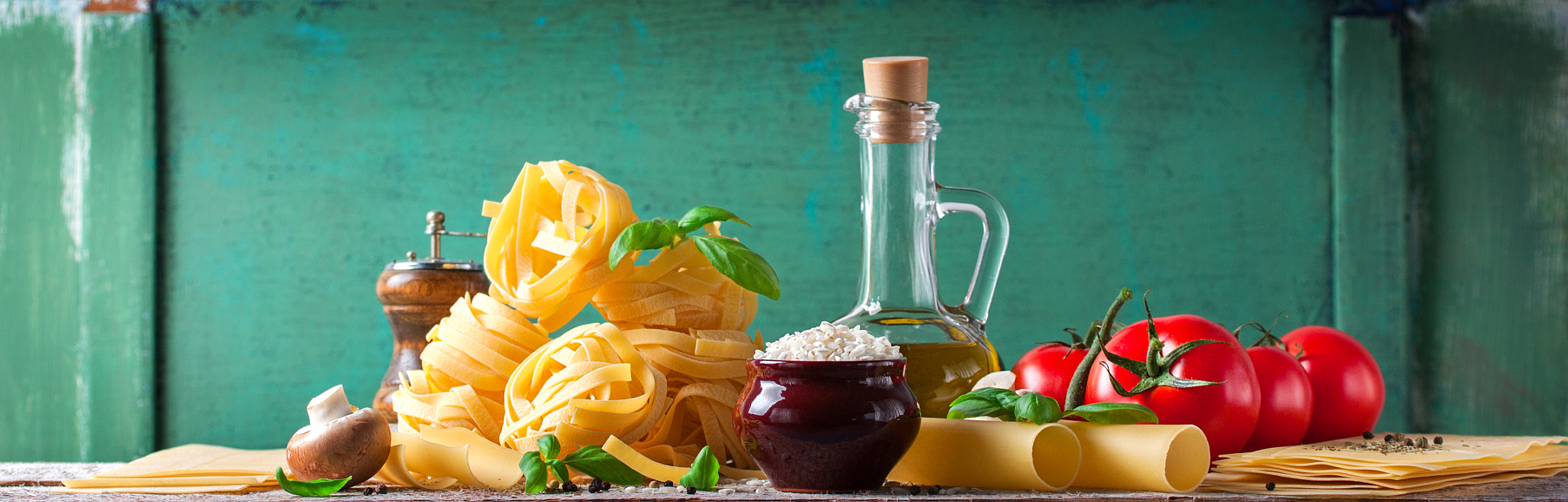 Food background or healthy concept with olive oil, fresh basil, pasta tagliatelle, rice,...