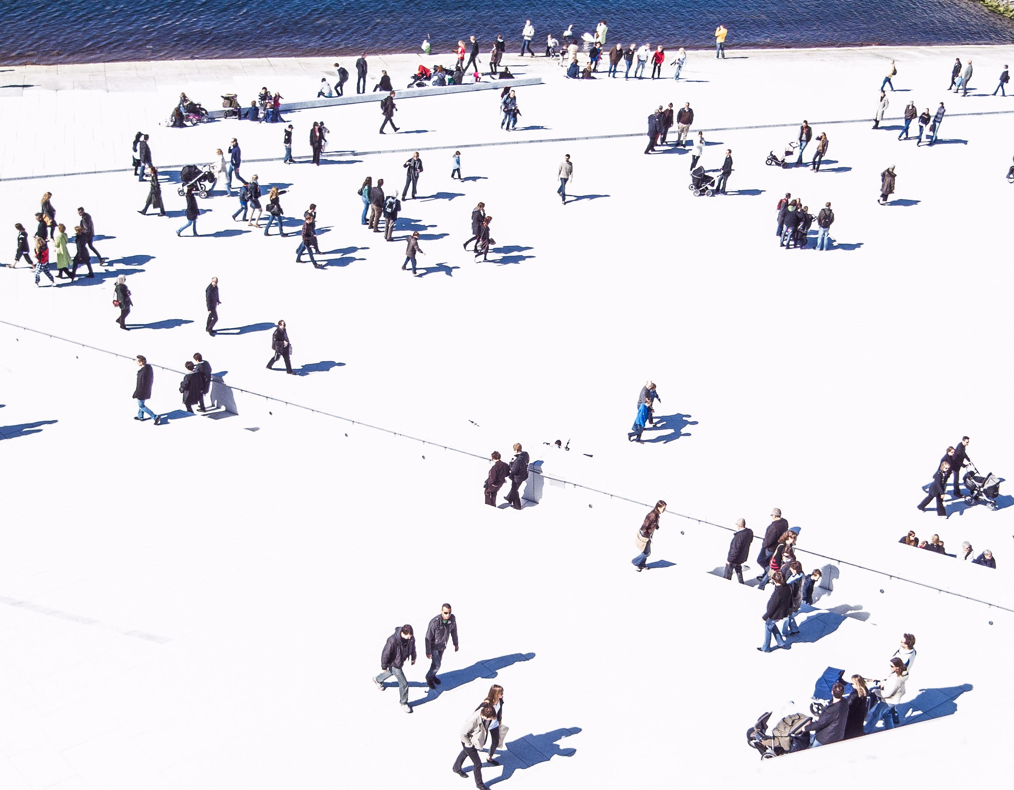 Ricoh Caplio GX100 sample photo. People walking on the marble exterior of oslo opera house in the low spring sun photography