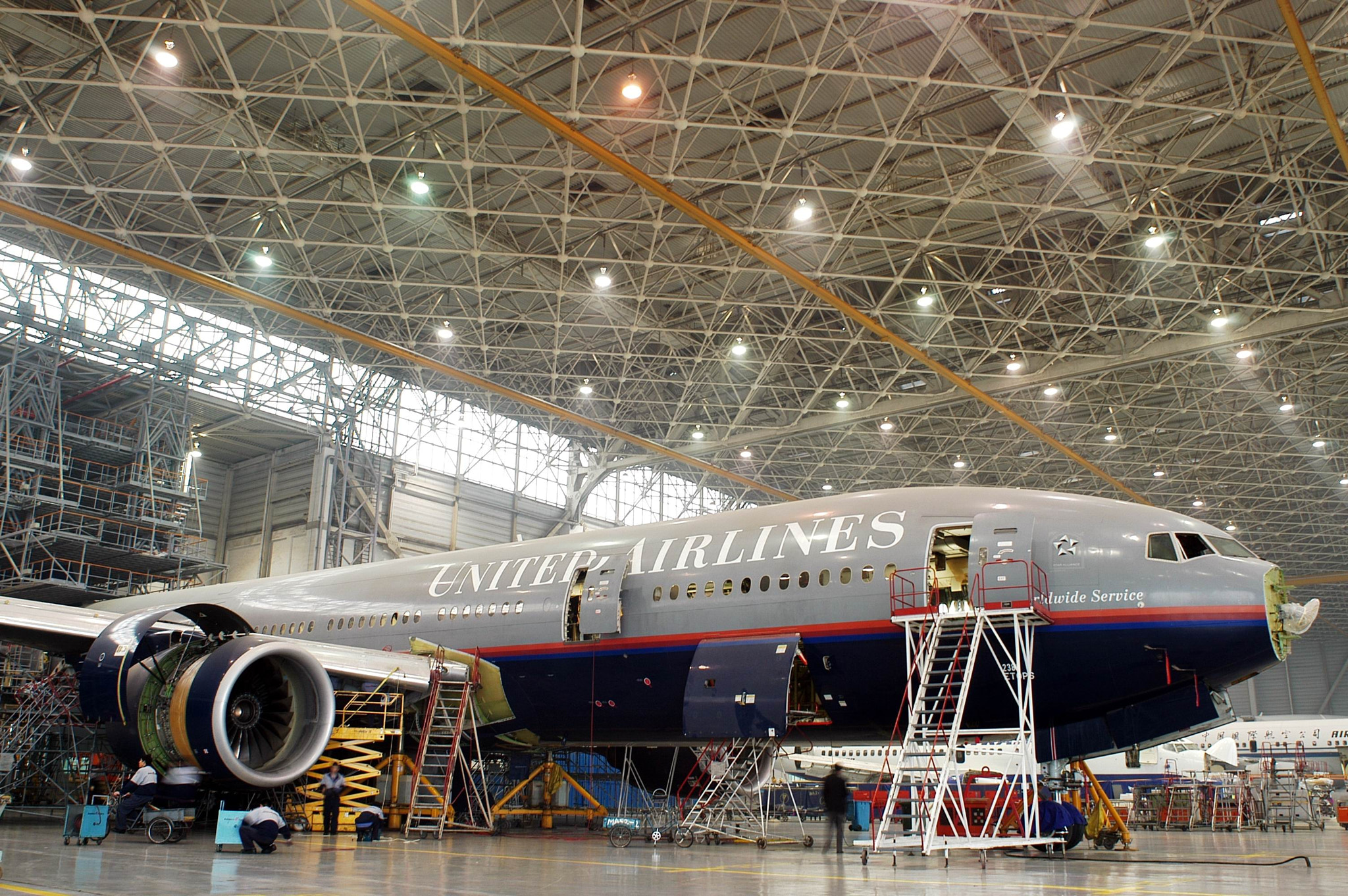 Nikon D100 + AF Nikkor 20mm f/2.8 sample photo. United airlines boeing 777 in hanger photography