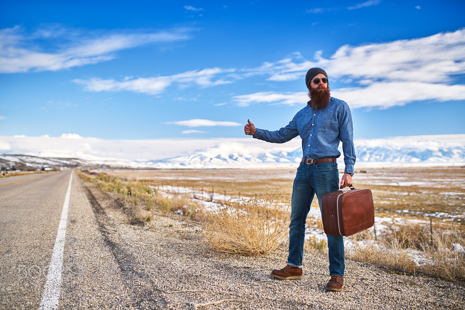 35mm F1.4 G SSM sample photo. Bearded hitch hiker thumbing for a ride on an empty nevada road photography