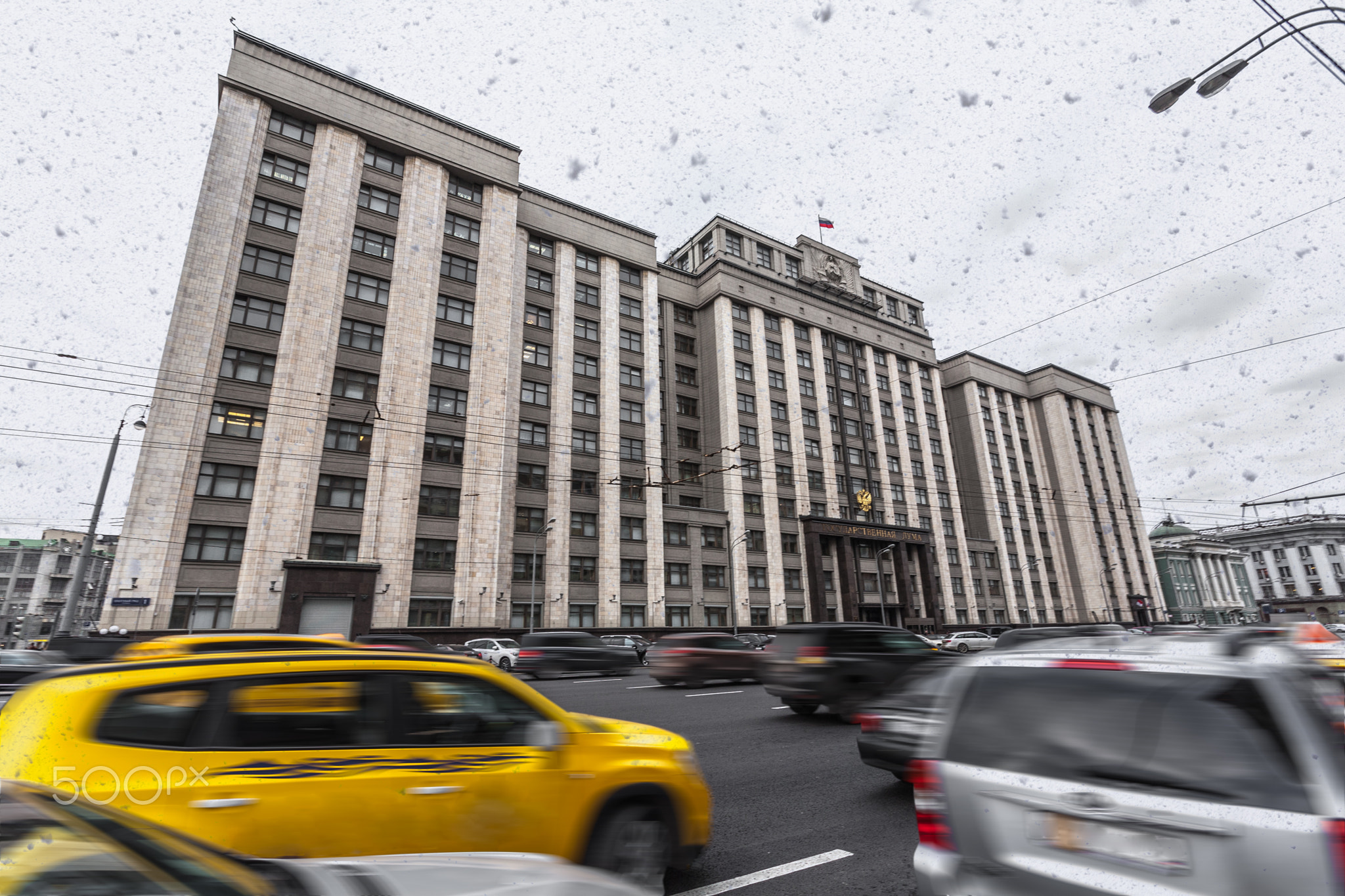 snow over the gloomy gray building