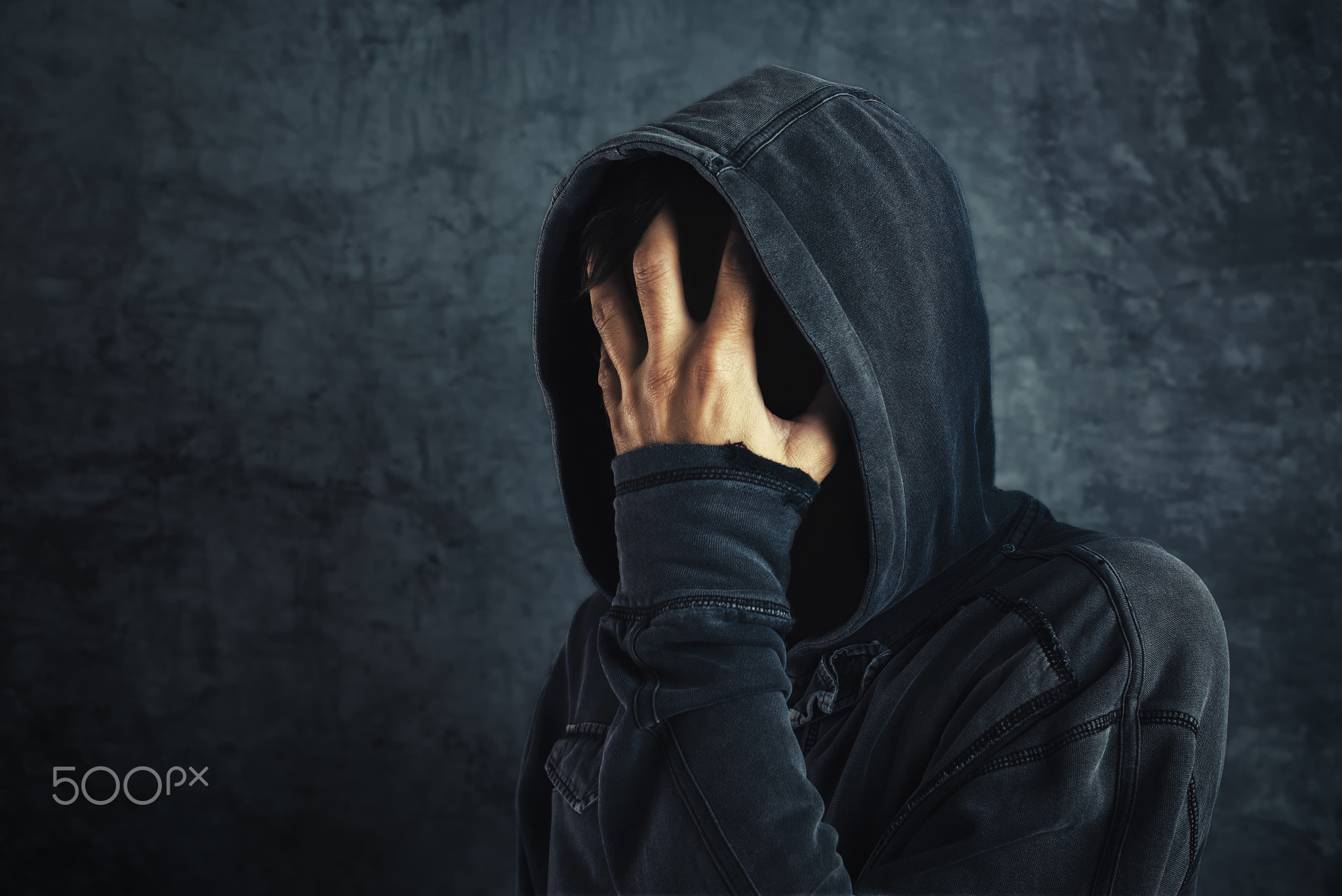 Hooded person fighting addiction crisis