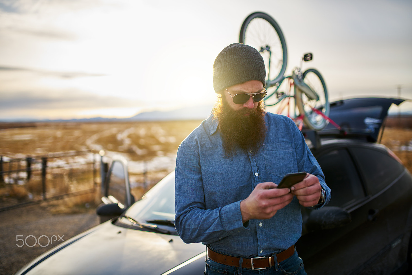 35mm F1.4 G SSM sample photo. Traveling bearded guy with bikes on his car using smart phone to look up directions photography