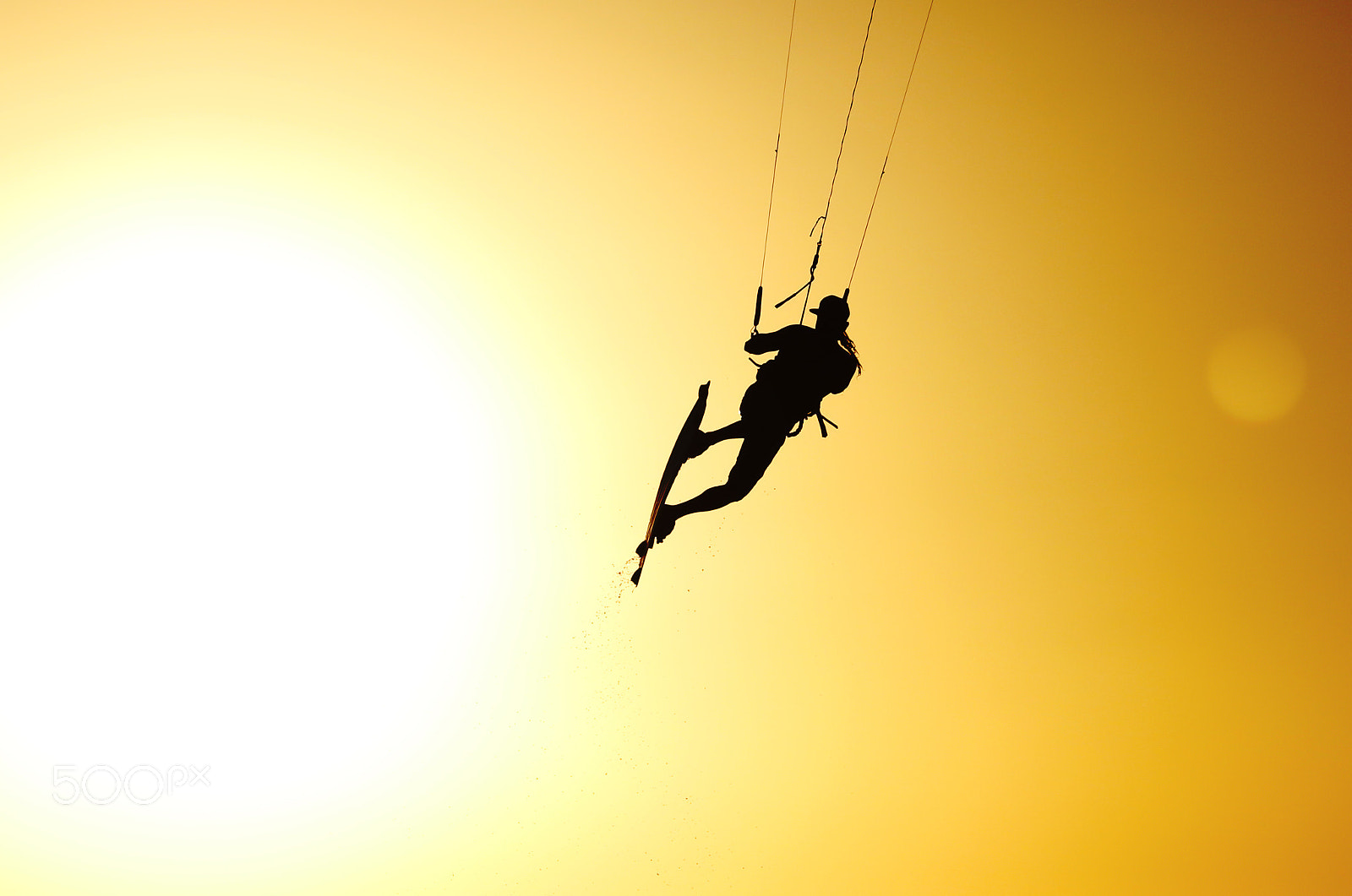 Canon EOS 7D Mark II + Canon EF 135mm F2L USM sample photo. Kiteboarder sportsman jumping under sunset sun photography