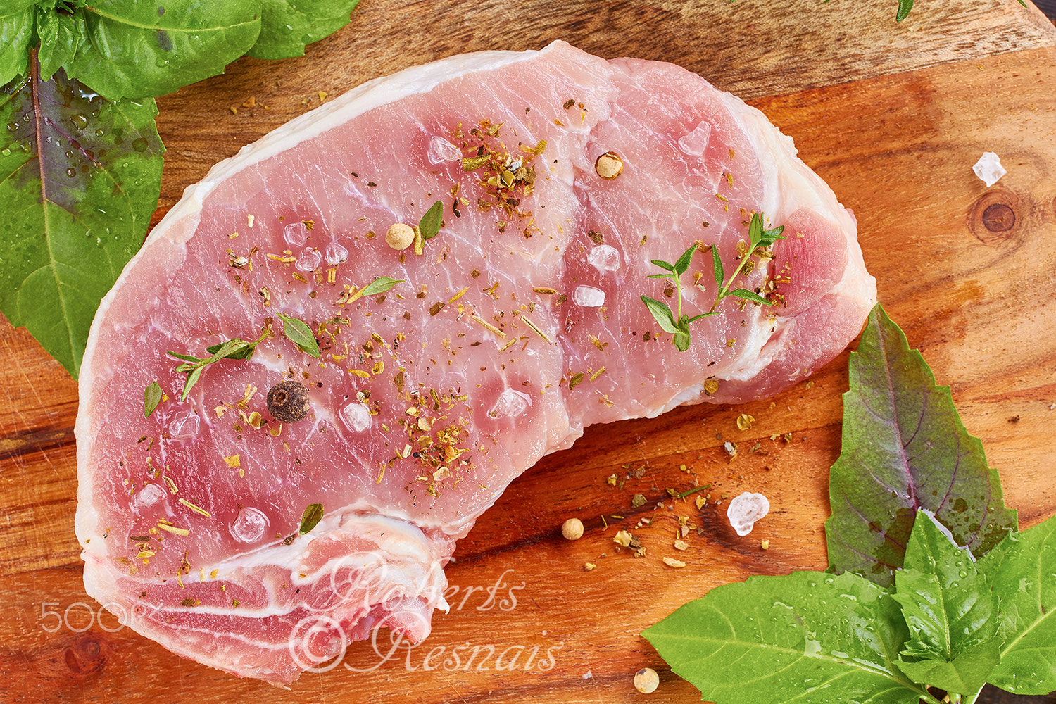 Canon EOS 60D + Canon EF 50mm F2.5 Macro sample photo. Raw pork meat with spices and herbs photography