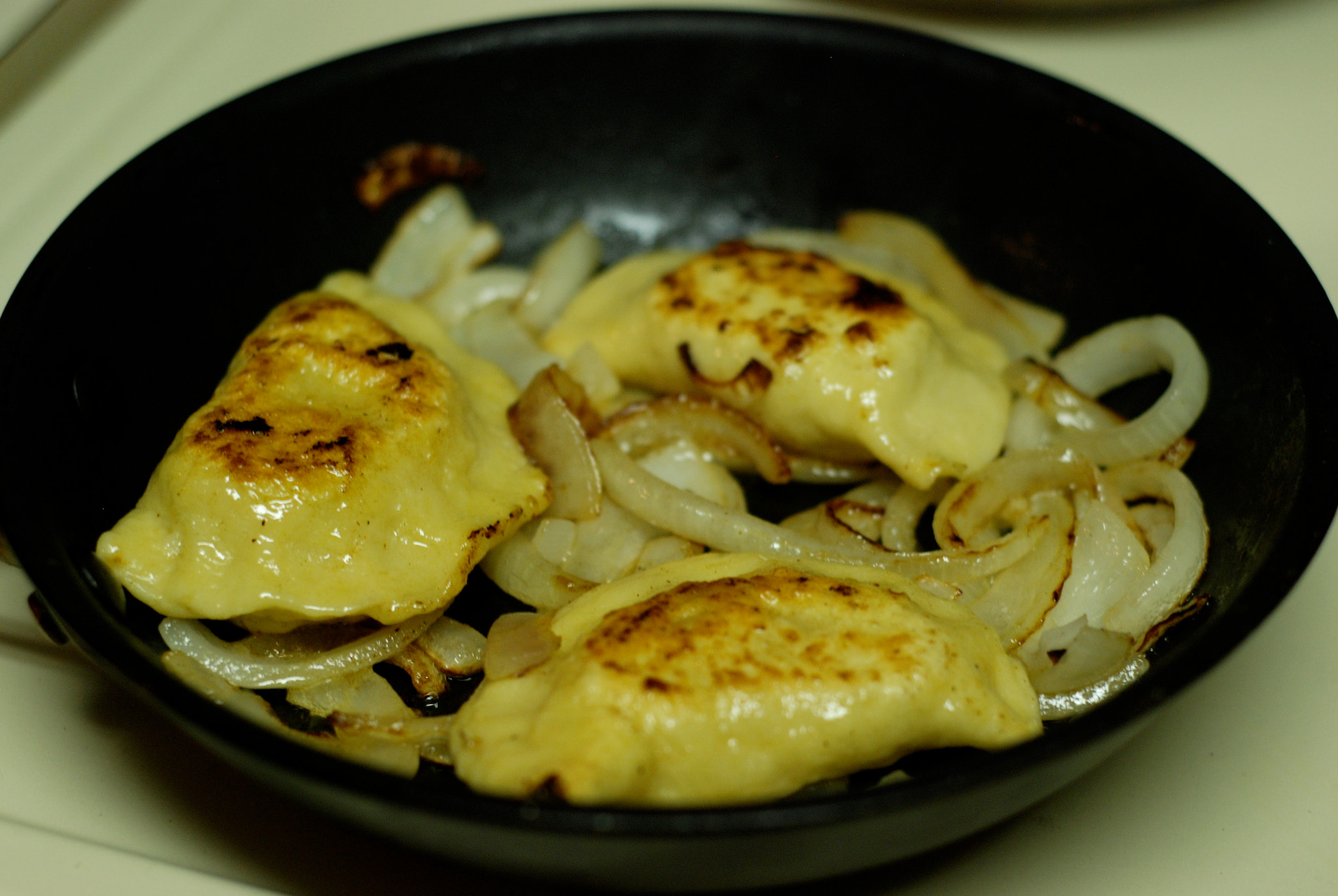 Nikon D80 + AF Nikkor 50mm f/1.8 sample photo. Onion and cheese perogies....... photography