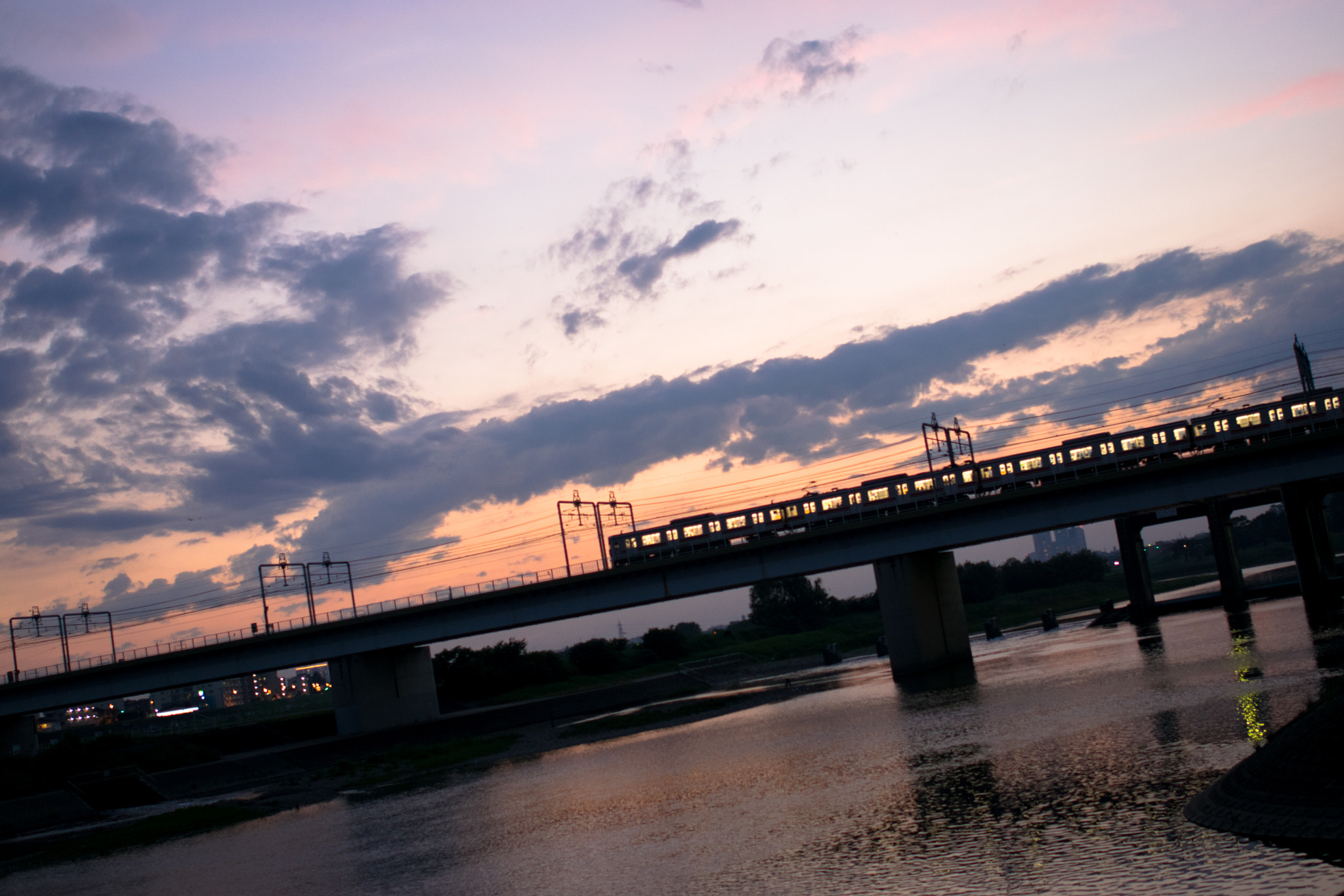 Nikon AF-S Nikkor 28mm F1.8G sample photo. Train on the bridge in the sunset photography