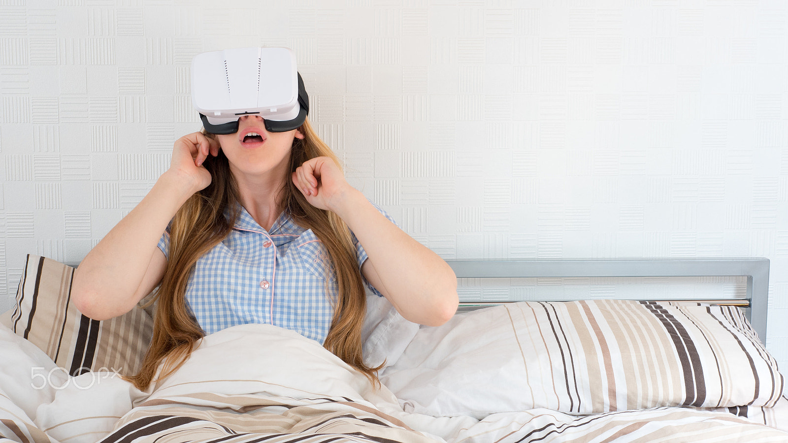 Panasonic Lumix DMC-GH4 + Panasonic Leica DG Summilux 25mm F1.4 II ASPH sample photo. Beautiful woman using vr headset in bed photography
