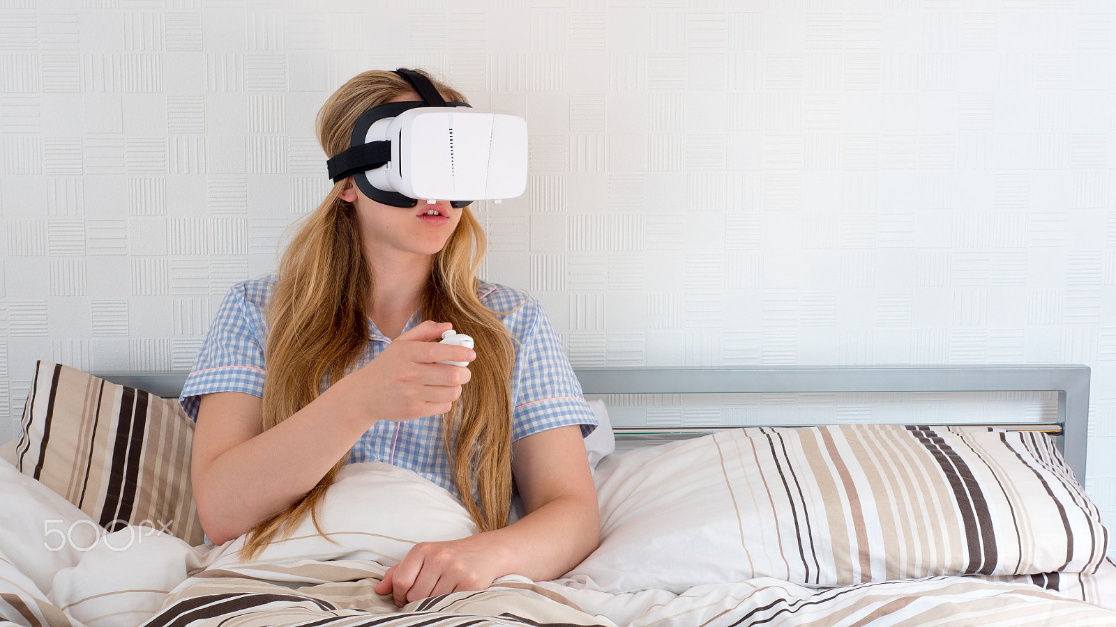 Panasonic Lumix DMC-GH4 + Panasonic Leica DG Summilux 25mm F1.4 II ASPH sample photo. Beautiful woman using vr headset in bed photography