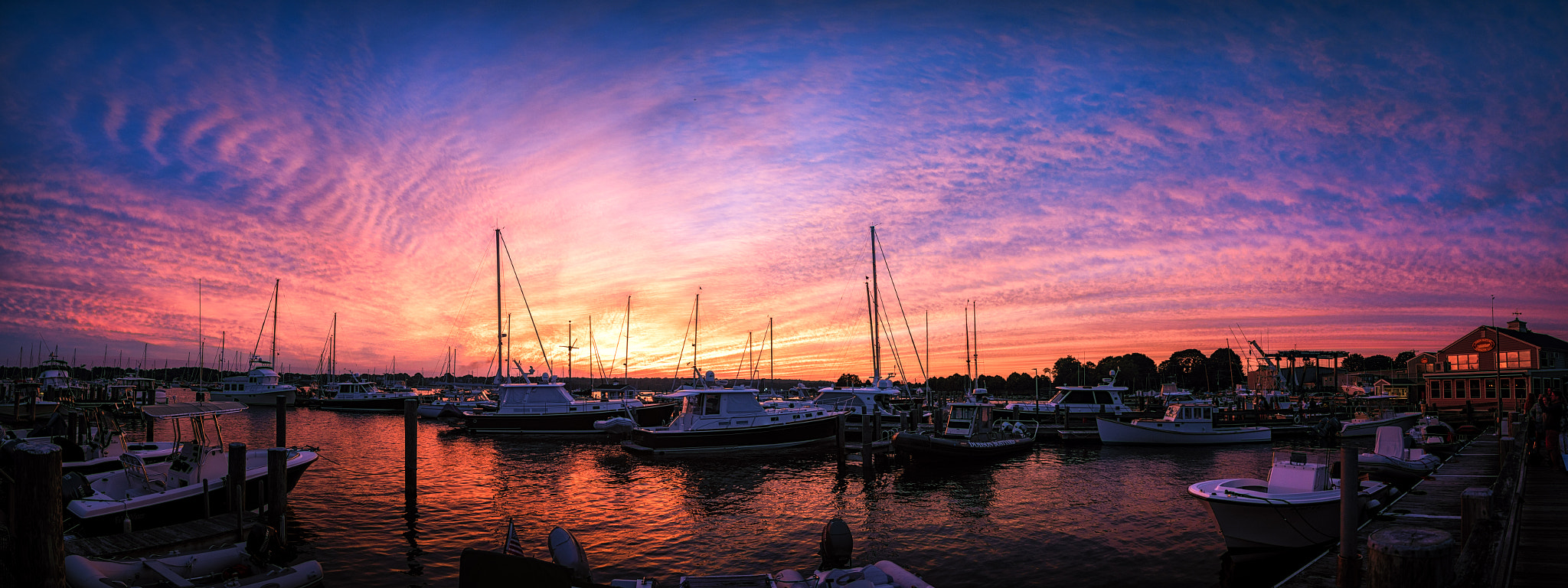 Panasonic Lumix DMC-GX85 (Lumix DMC-GX80 / Lumix DMC-GX7 Mark II) sample photo. Red clouds, white boats, blue skies photography