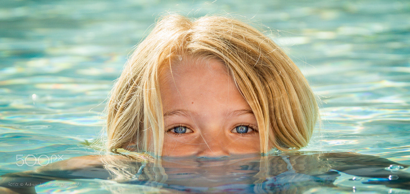 Canon EF 28-300mm F3.5-5.6L IS USM sample photo. Girl swimming, eyes above water line photography