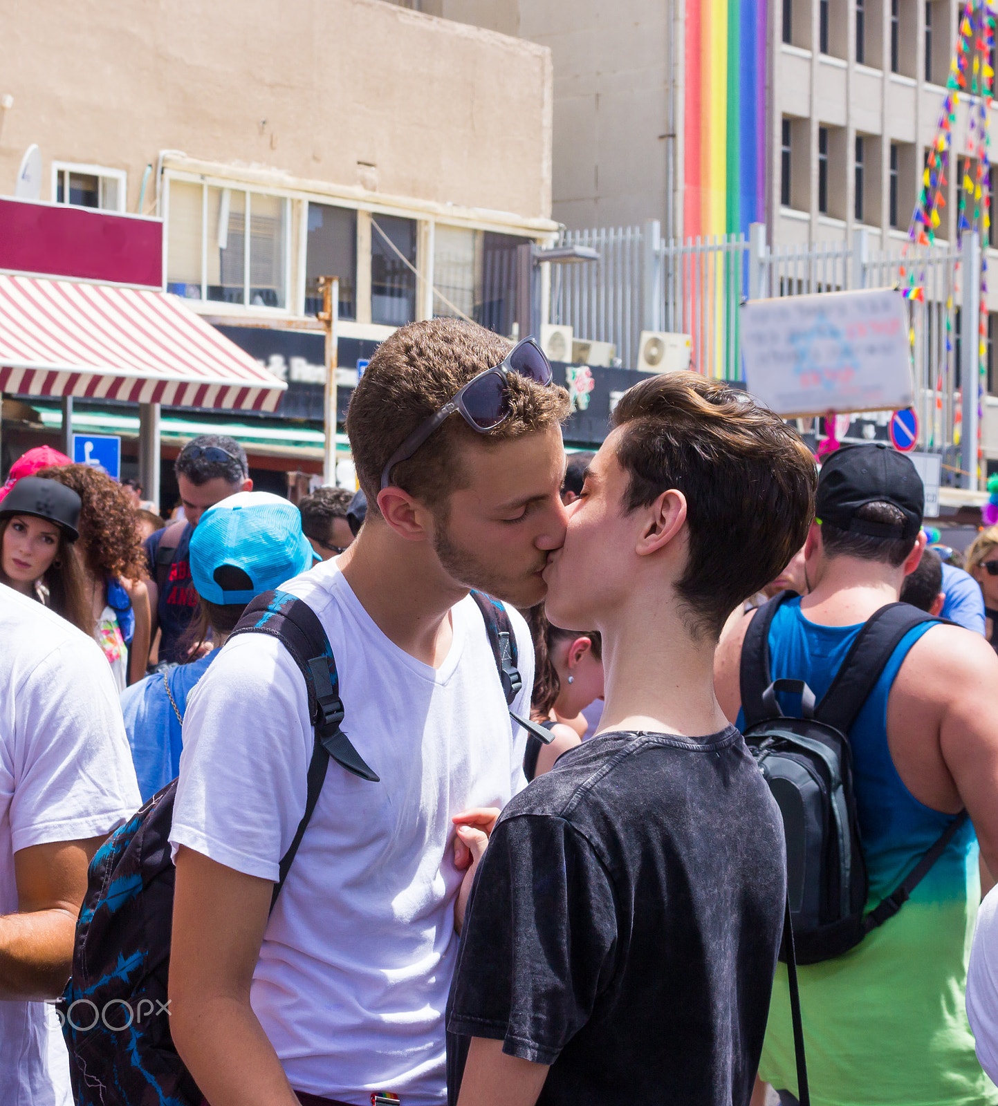 Canon EF 75-300mm F4.0-5.6 IS USM sample photo. Members of pride parade surrounded by other people photography
