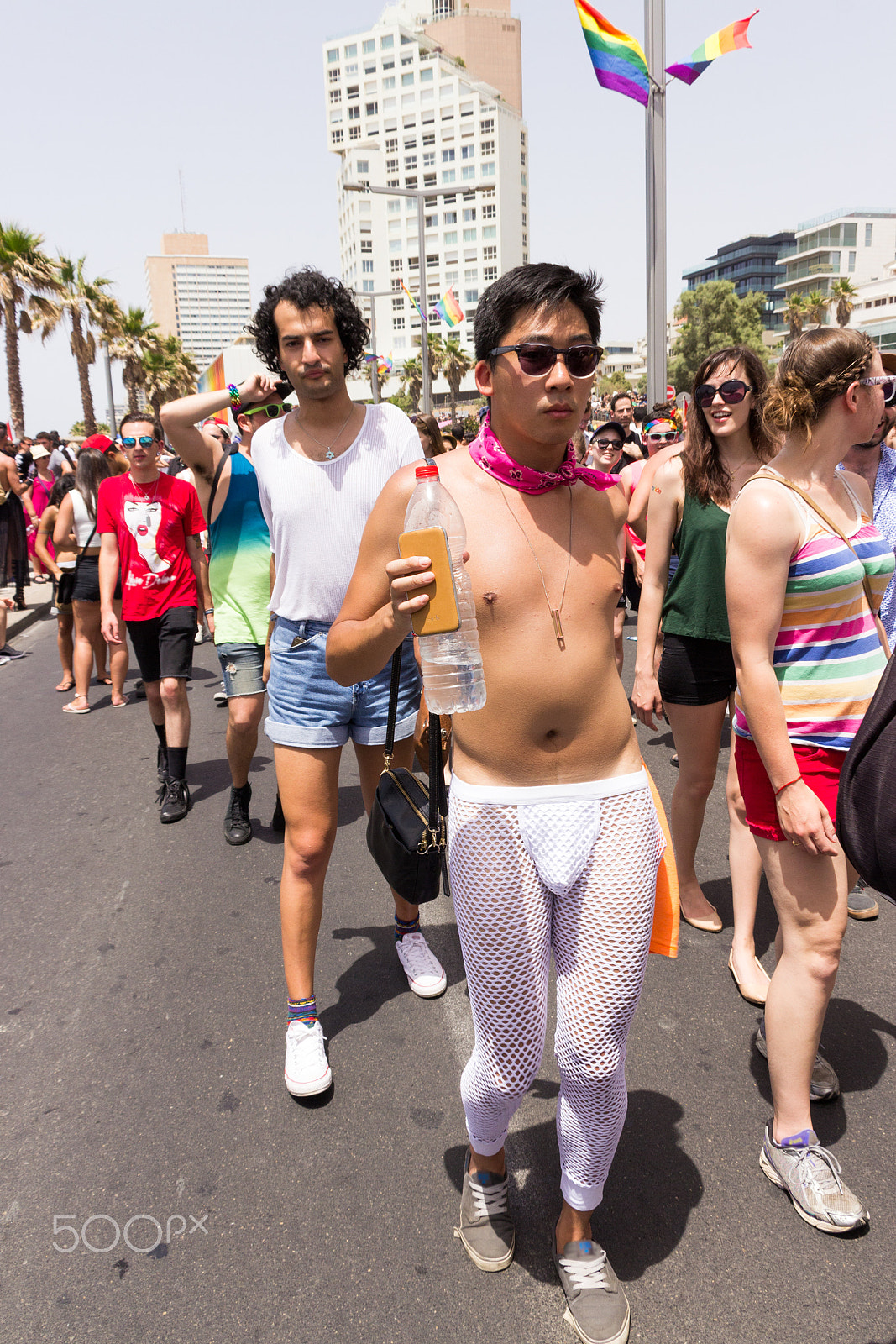 Canon EF 75-300mm F4.0-5.6 IS USM sample photo. Members of pride parade surrounded by other people photography