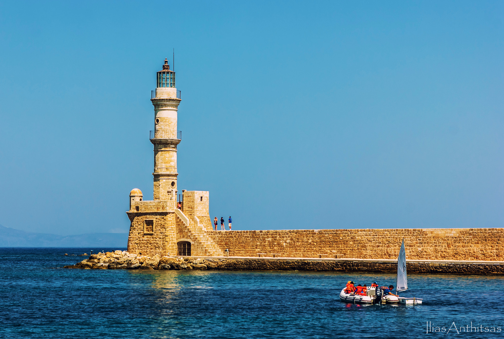 Canon EOS 550D (EOS Rebel T2i / EOS Kiss X4) + Sigma 24-70mm F2.8 EX DG Macro sample photo. Lighthouse in chania port photography