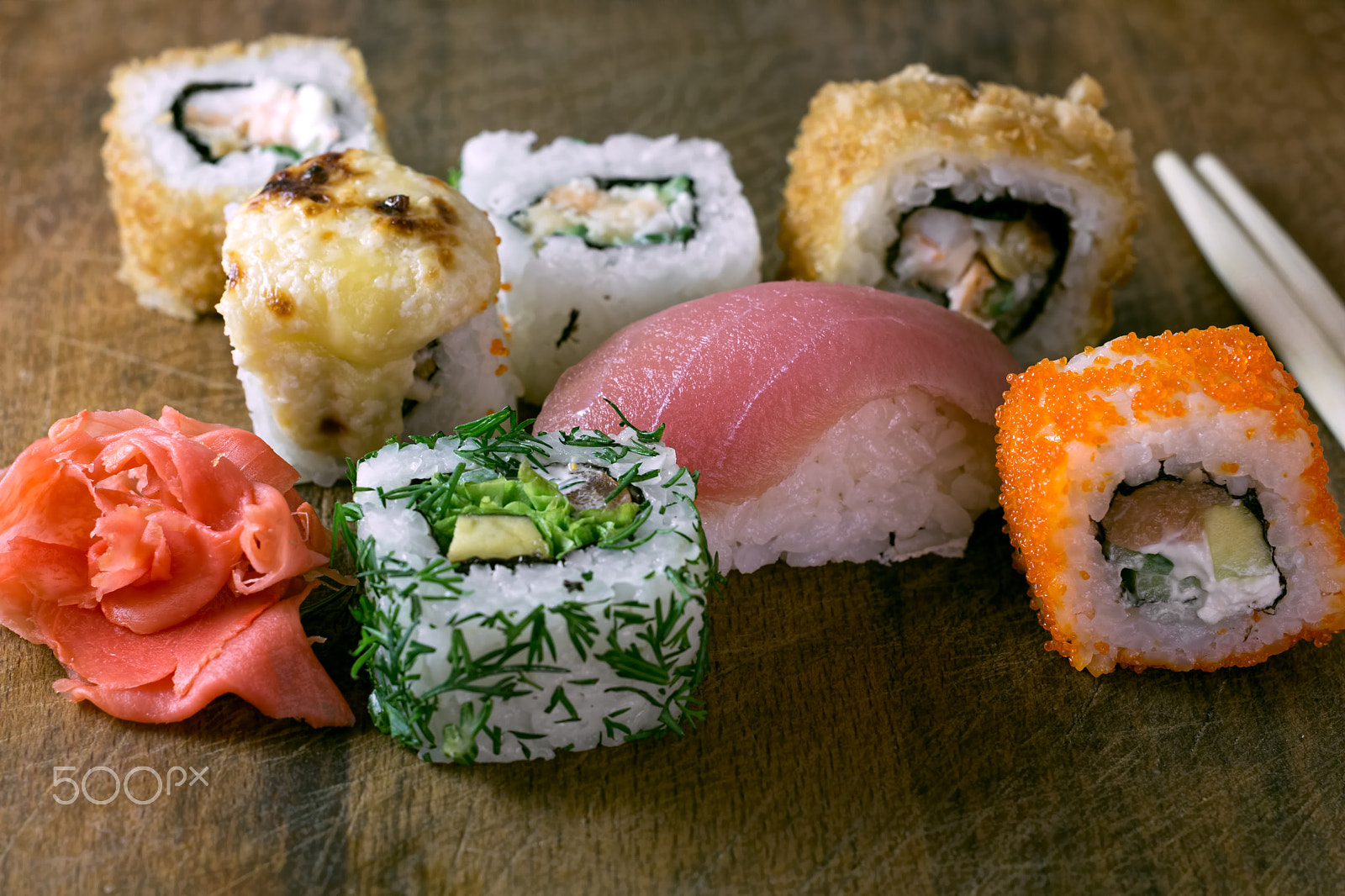 Canon EF 35-80mm f/4-5.6 sample photo. Rolls and sushi on a wooden board with chopsticks photography