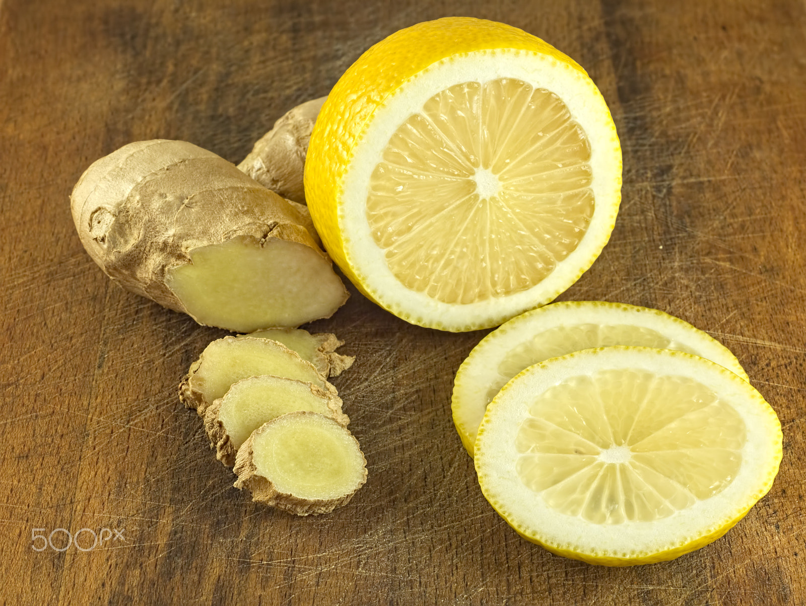 Canon EF 35-80mm f/4-5.6 sample photo. Lemon and ginger root chopped slices on a wooden background photography