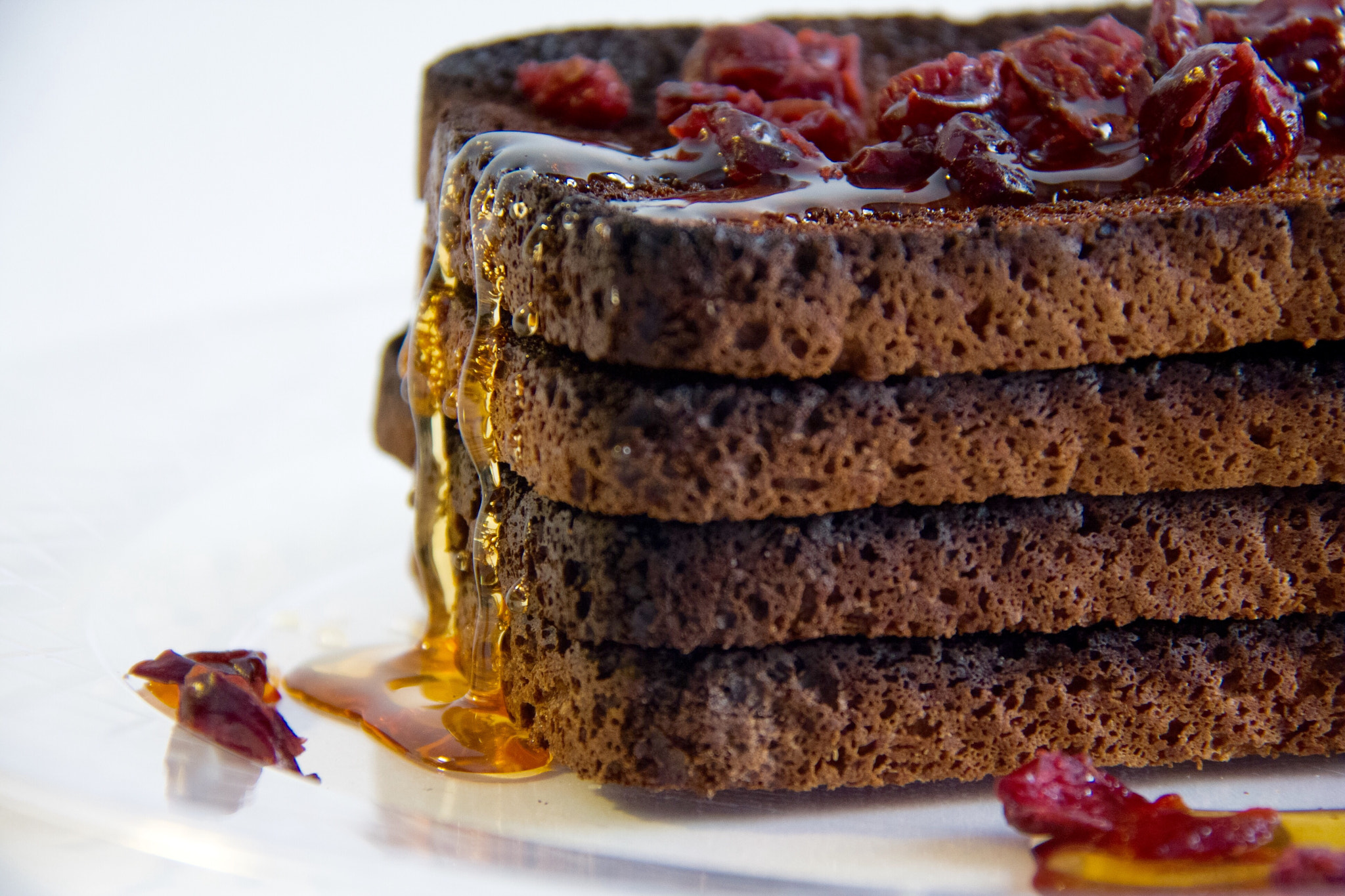 Canon EOS 40D + Canon EF-S 18-200mm F3.5-5.6 IS sample photo. Burnt toast topped with cranberries drizzled with honey. photography