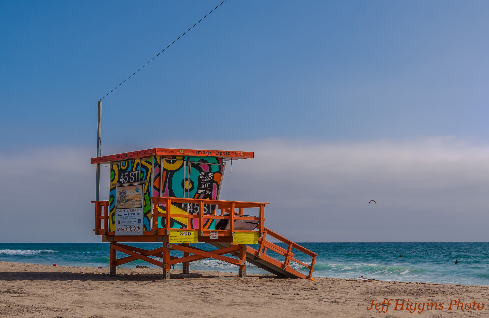 Canon EOS 50D sample photo. Lifeguard tower with bird flying in the distance. photography