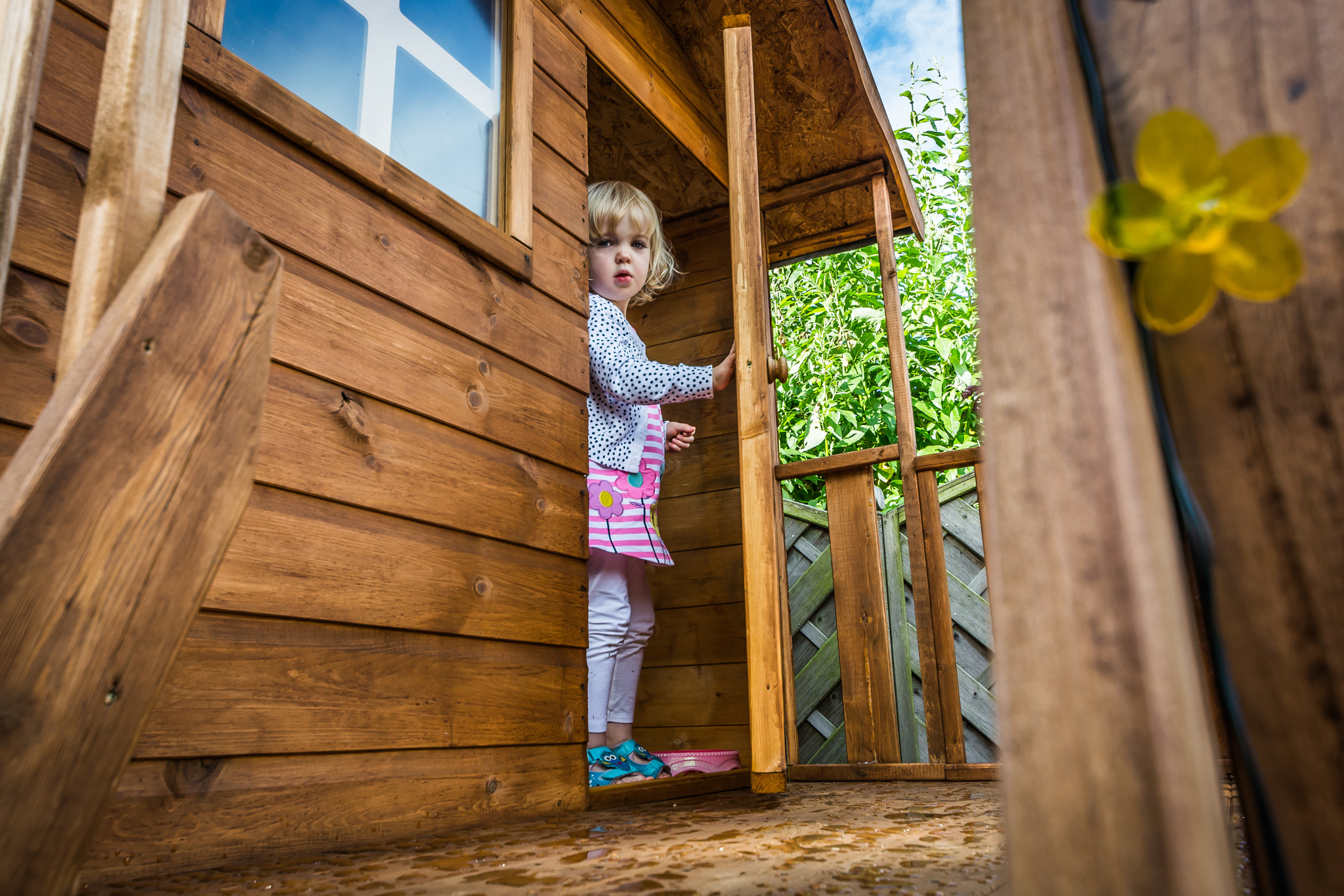 Nikon D5200 + Sigma 8-16mm F4.5-5.6 DC HSM sample photo. Little girl emerging from her playhouse photography